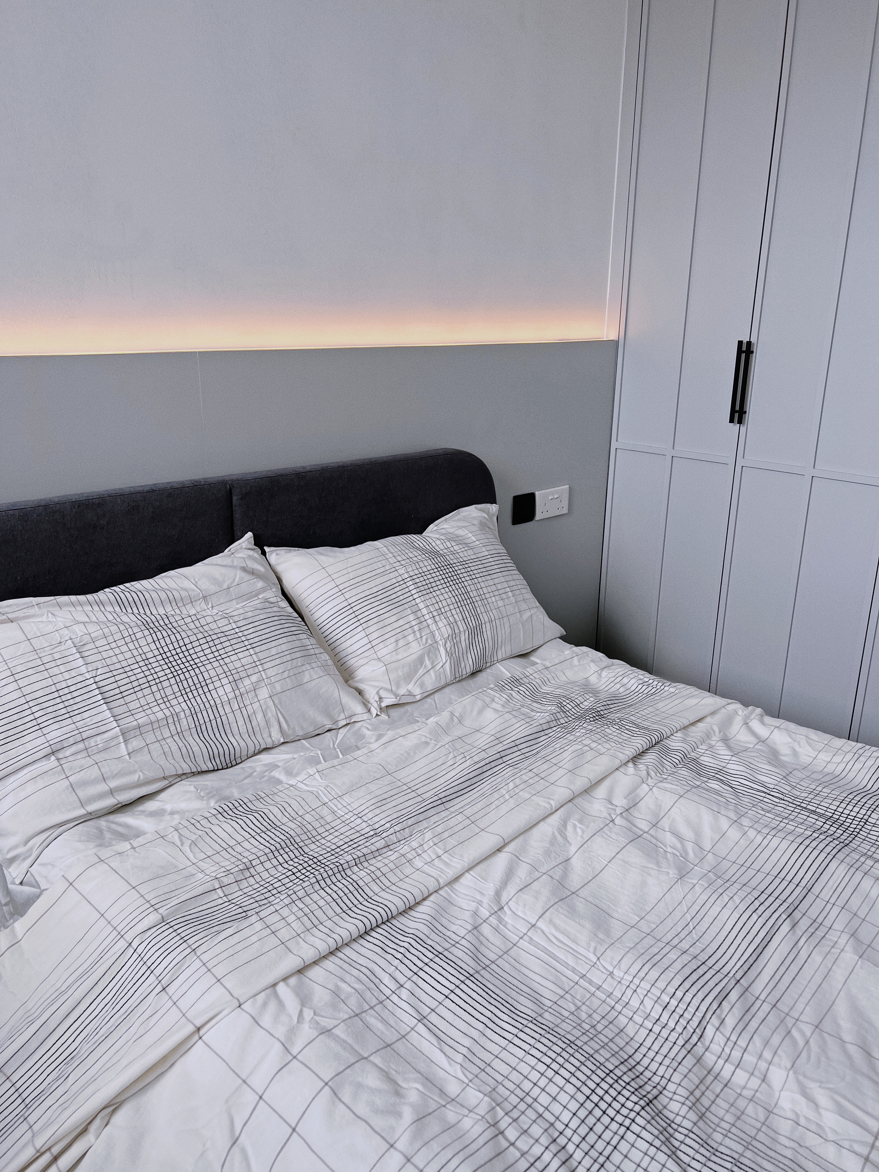 Spacious & Functional Master Bedroom  - modern bedroom, minimalist design, cozy bed, white and black checkered comforter