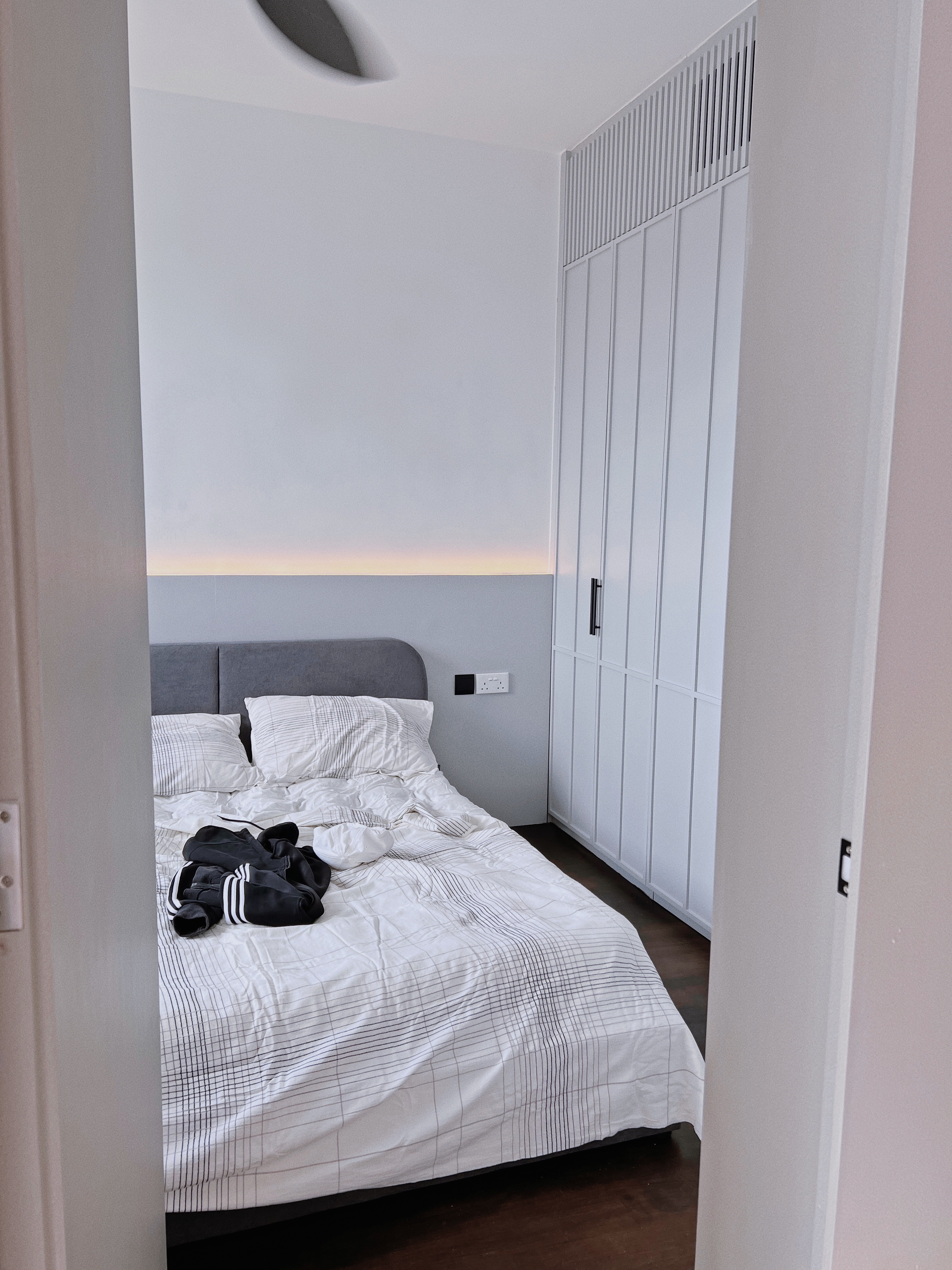 Spacious & Functional Master Bedroom  - modern bedroom, minimalist design, cozy bed, white and black striped comforter, gray