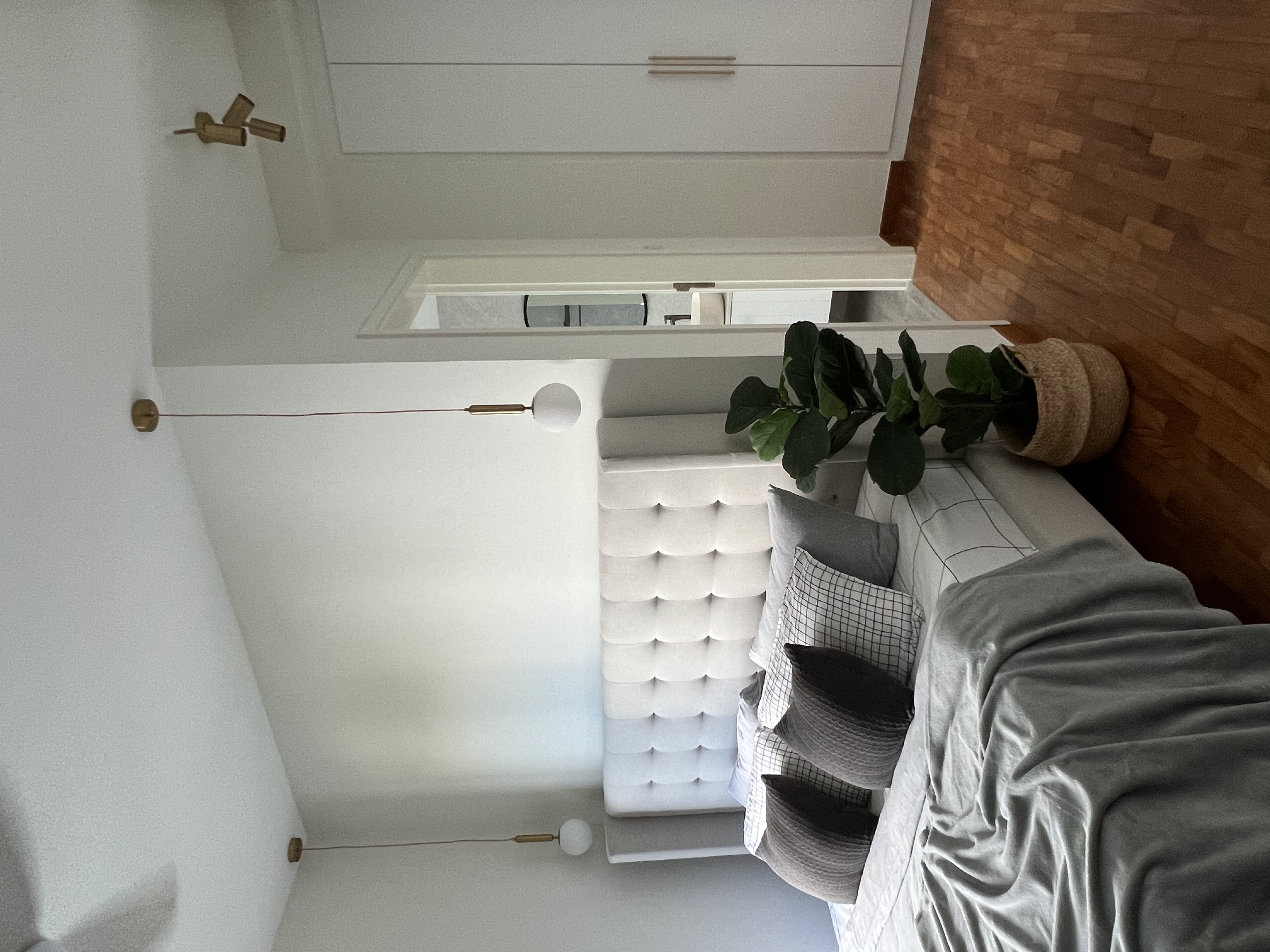 Sleek Comfort For A Good Night Rest - White minimalist bedroom, modern decor, cozy bed, tufted headboard, wooden accent wall