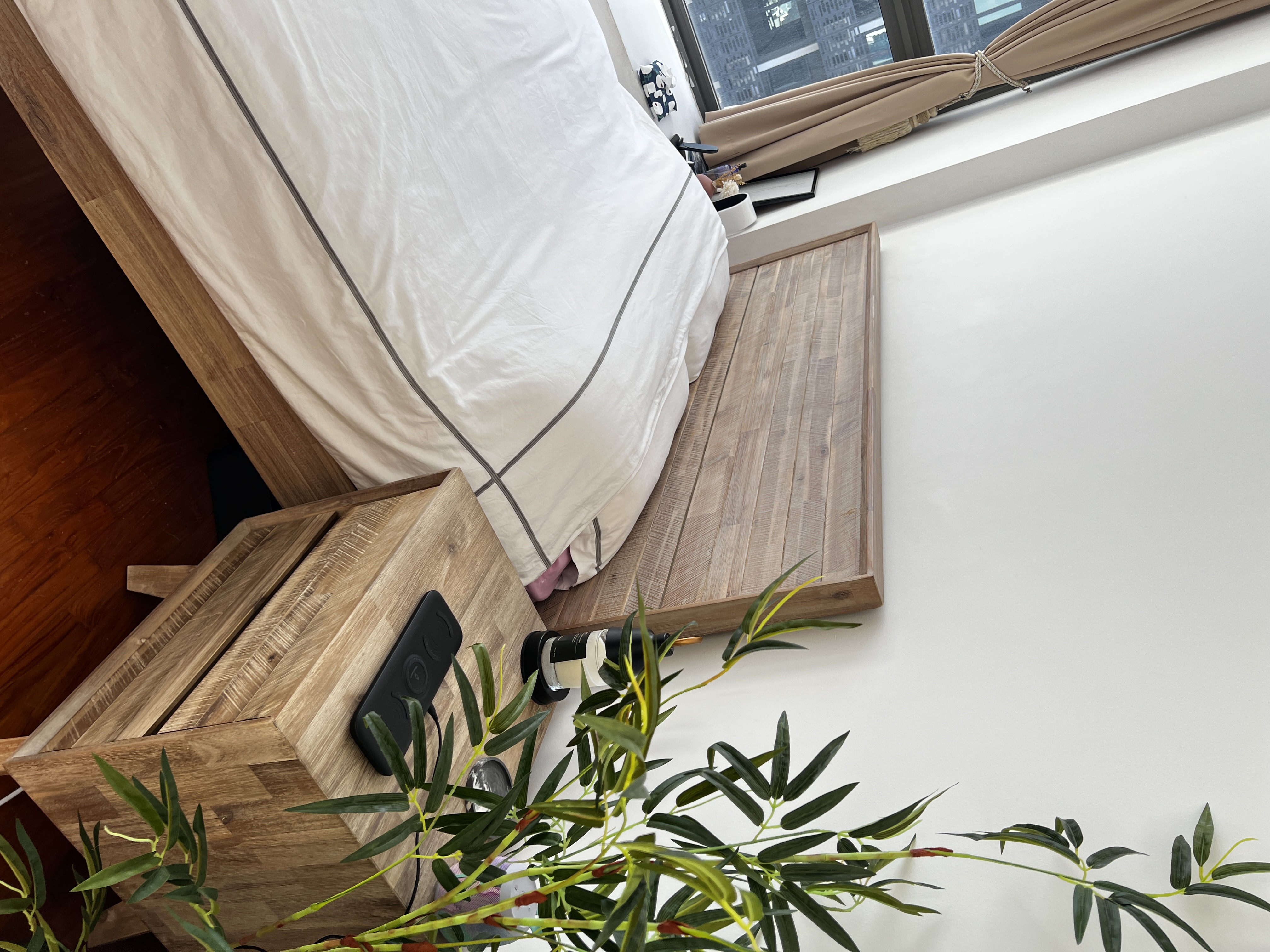 Nordic-Minimalist Inspired Bedroom  - Wooden nightstand, beige curtains, urban cityscape, modern bedroom, wooden flooring