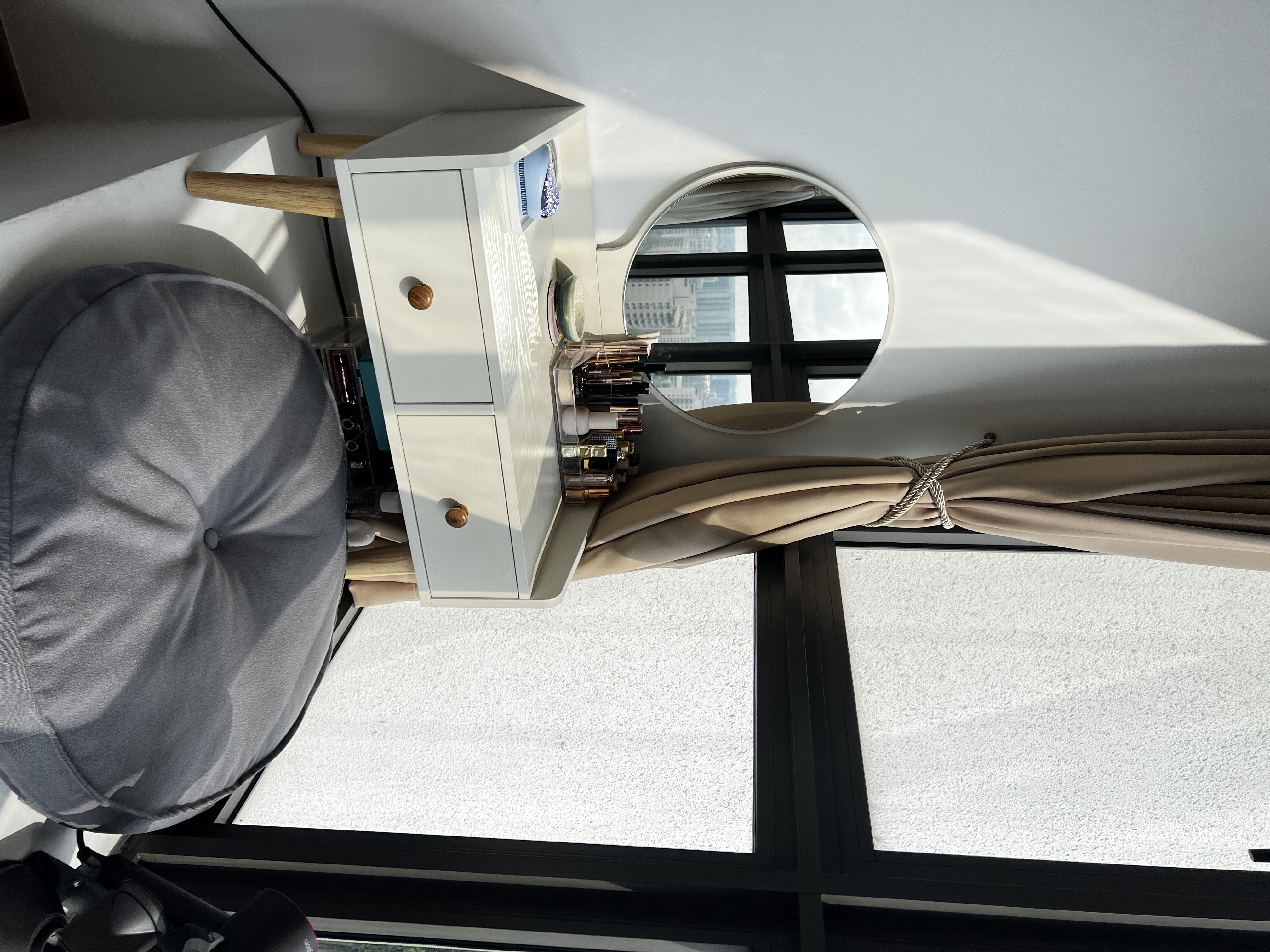 Nordic-Minimalist Inspired Bedroom  - White vanity with wooden handles, beige curtains, cityscape view through large windows
