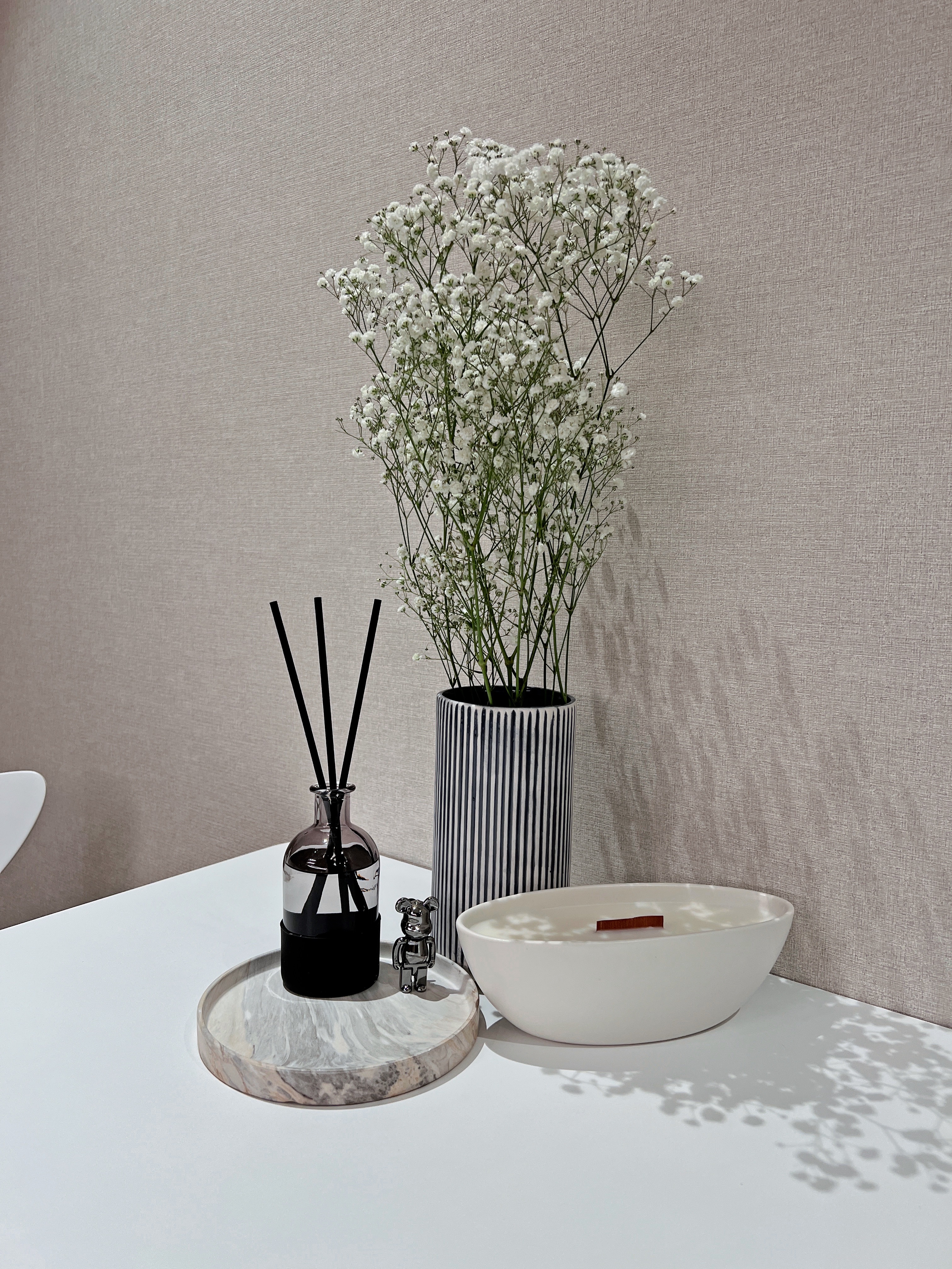 Chic Dining Area For Eating & Hosting  - vase, white flowers, black sticks, striped vase, modern decor, minimalist design