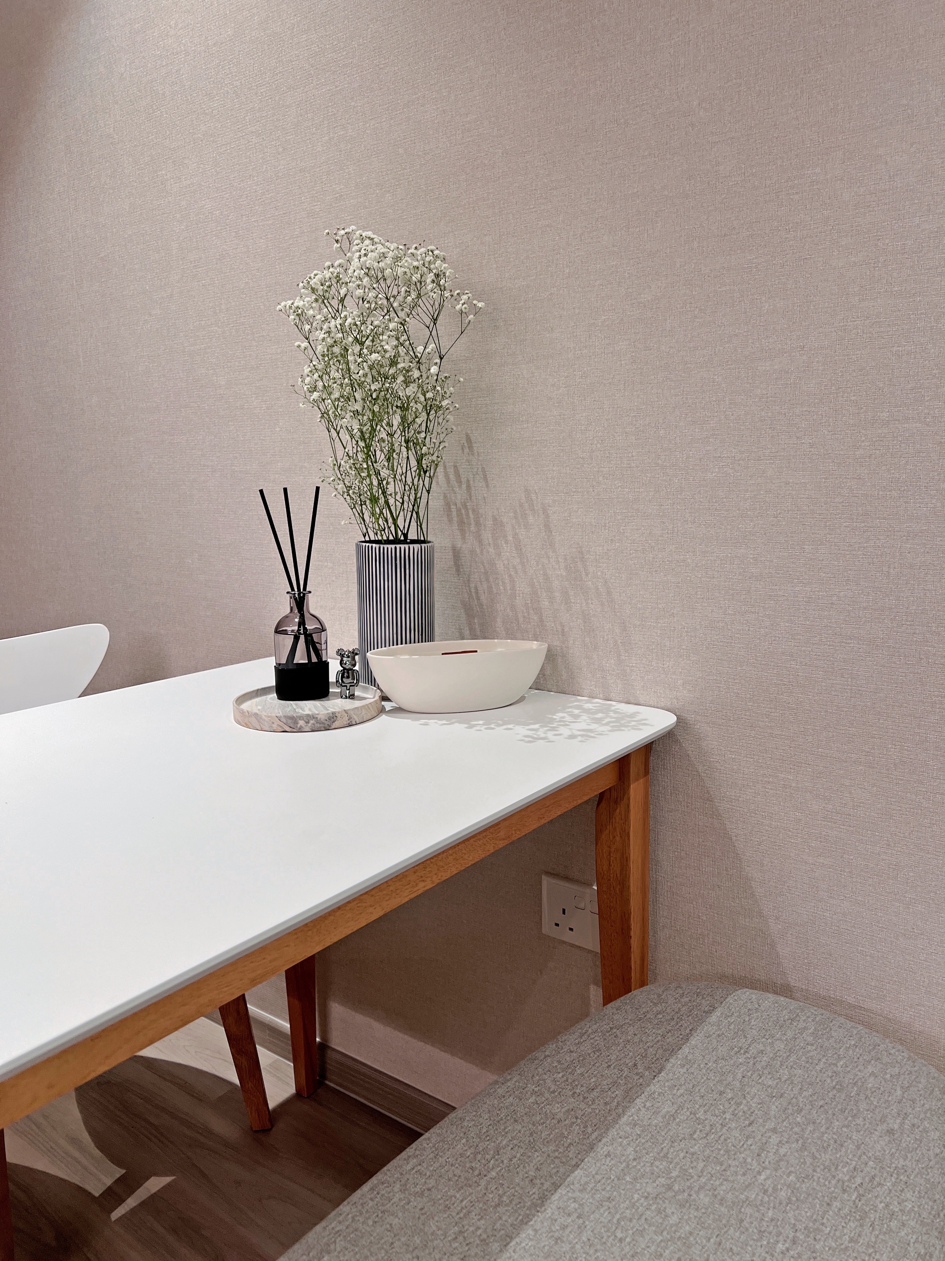 Chic Dining Area For Eating & Hosting  - White modern bathroom vanity, minimalist design, textured beige wall, sleek black