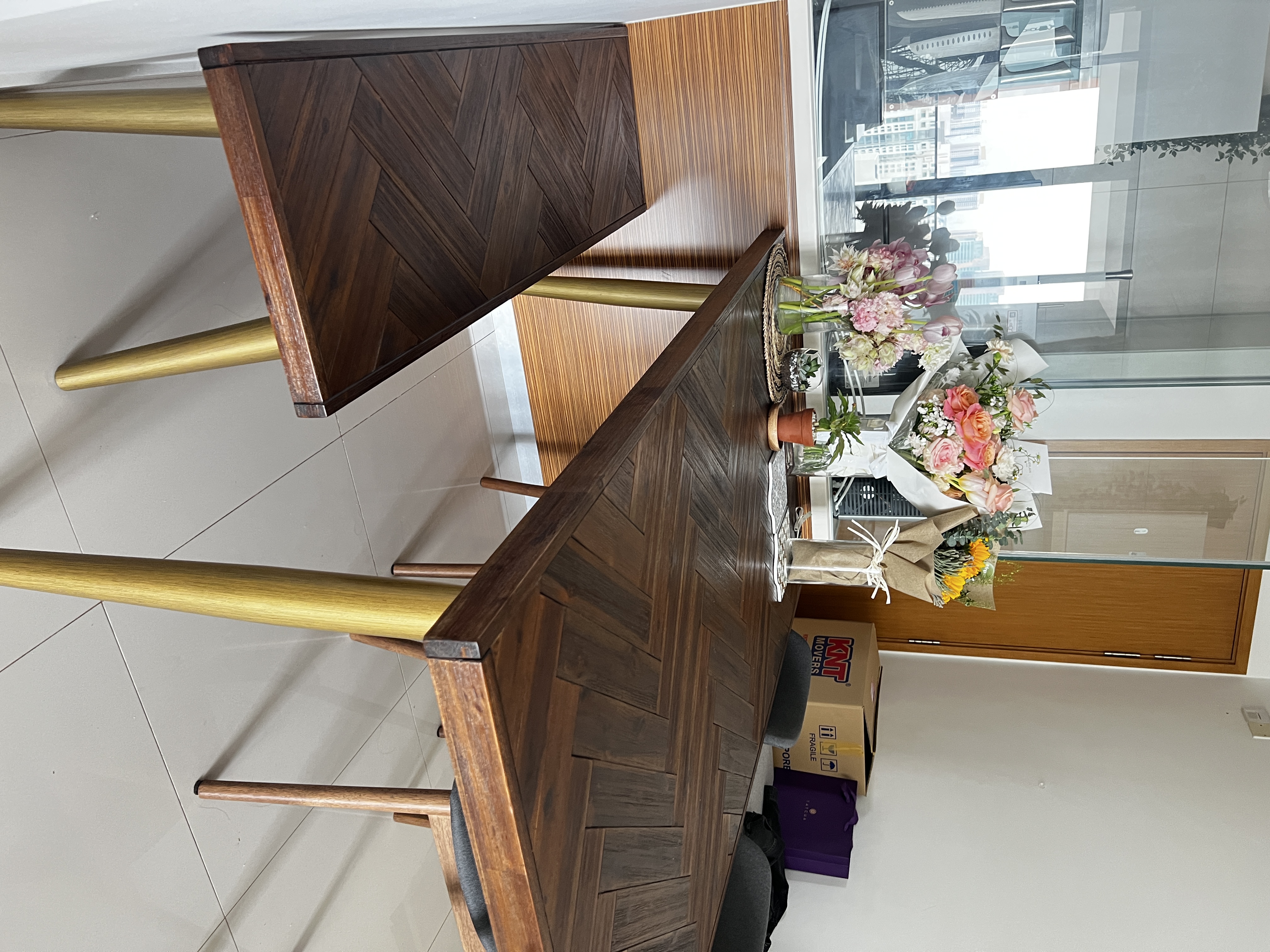 Small Yet Functional Dining Area  - Wooden dining table with chevron pattern, gold metal legs, modern interior design, wooden