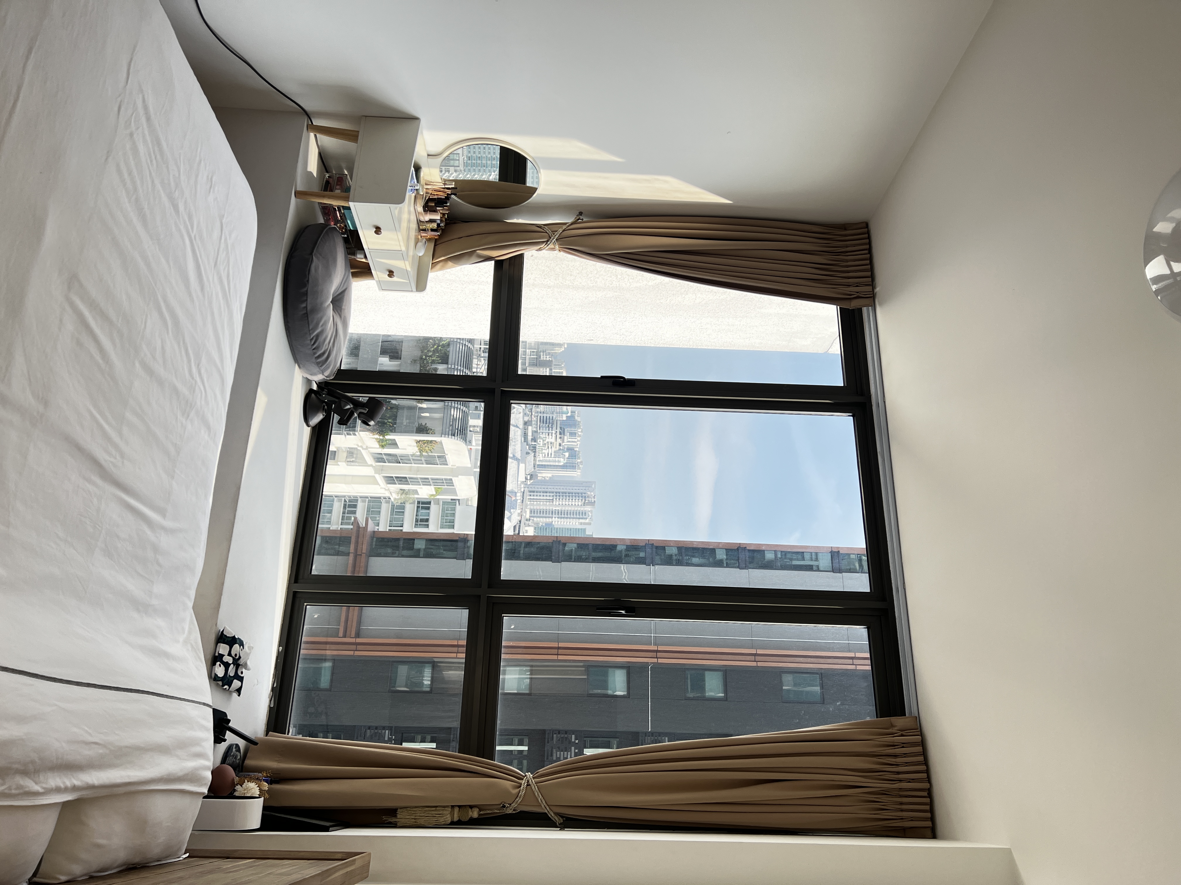 Bright & Sunny Cosy Corner - Large window, cityscape, tall buildings, clear sky, natural light, modern interior, cozy