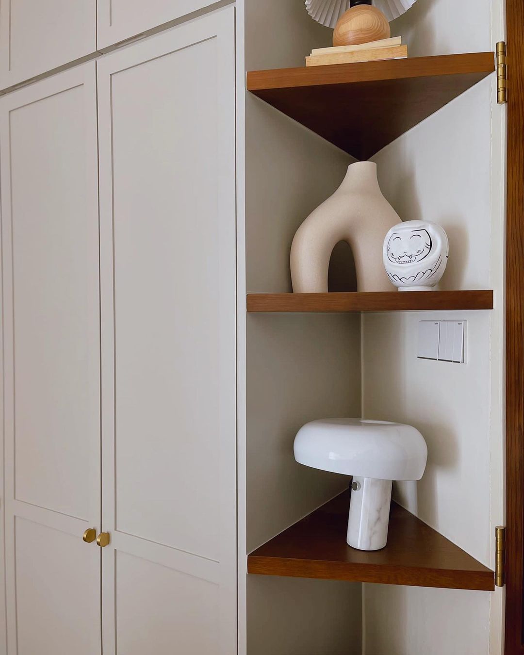 Purr-fectly Styled Nook - White cabinetry, wooden shelves, minimalist design, modern decor, decorative vases, abstract art