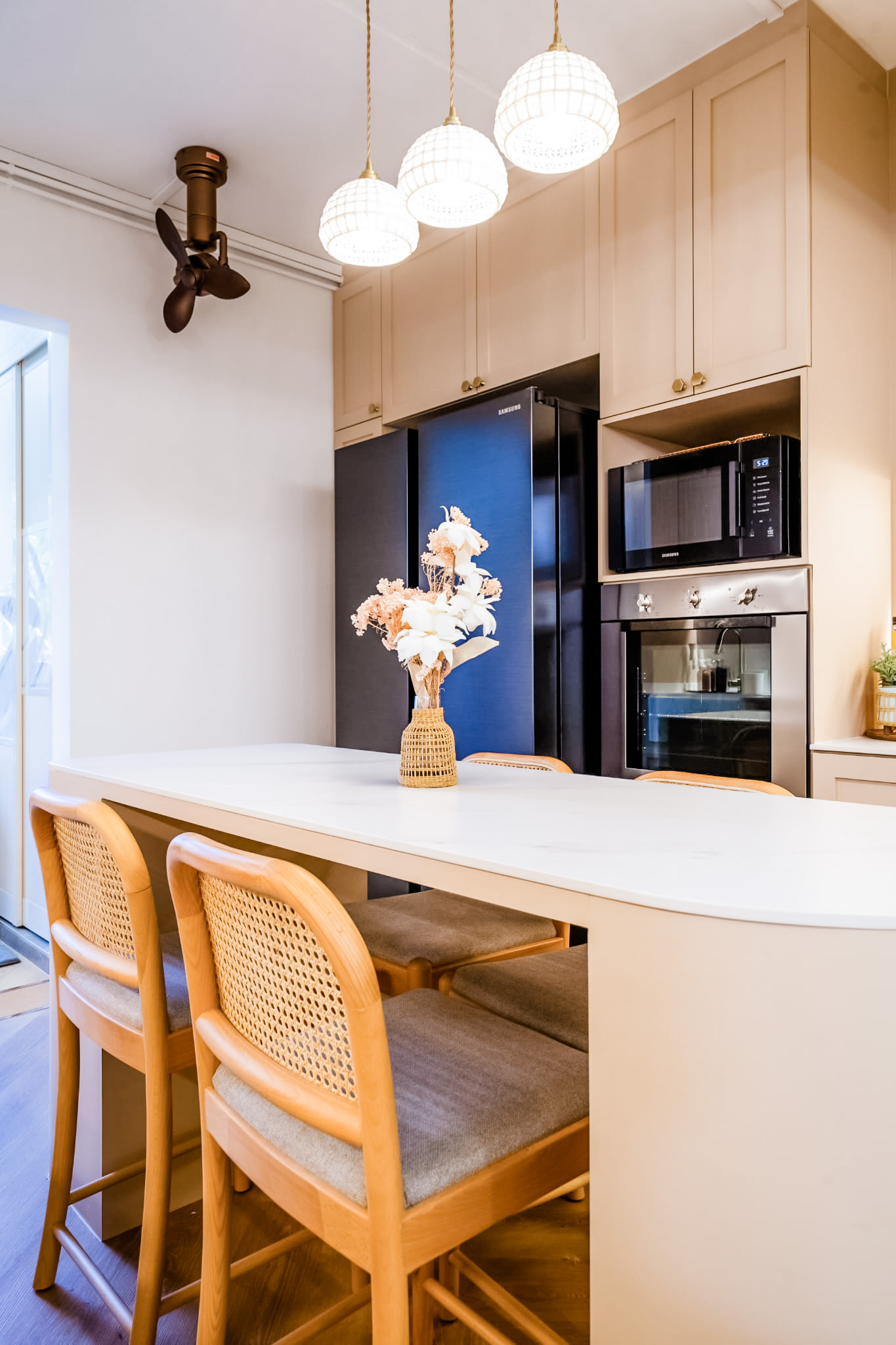 Kitchen is the soul of our home! - Modern kitchen with white countertops, wooden dining chairs, built-in appliances, pendant