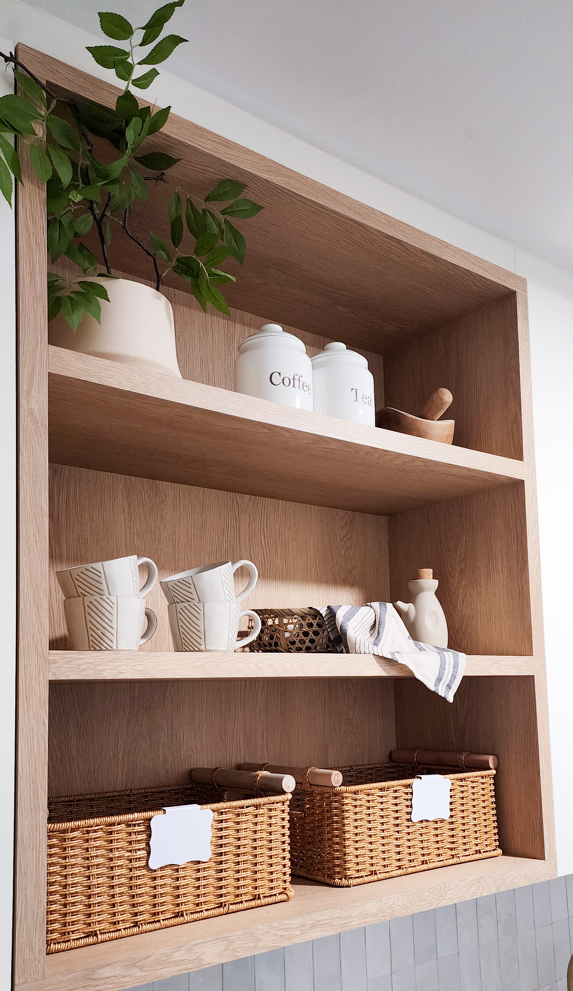 Farmhouse inspired kitchen built from scratch - Wooden shelf, green plant, white ceramic jars, white ceramic cups, wooden