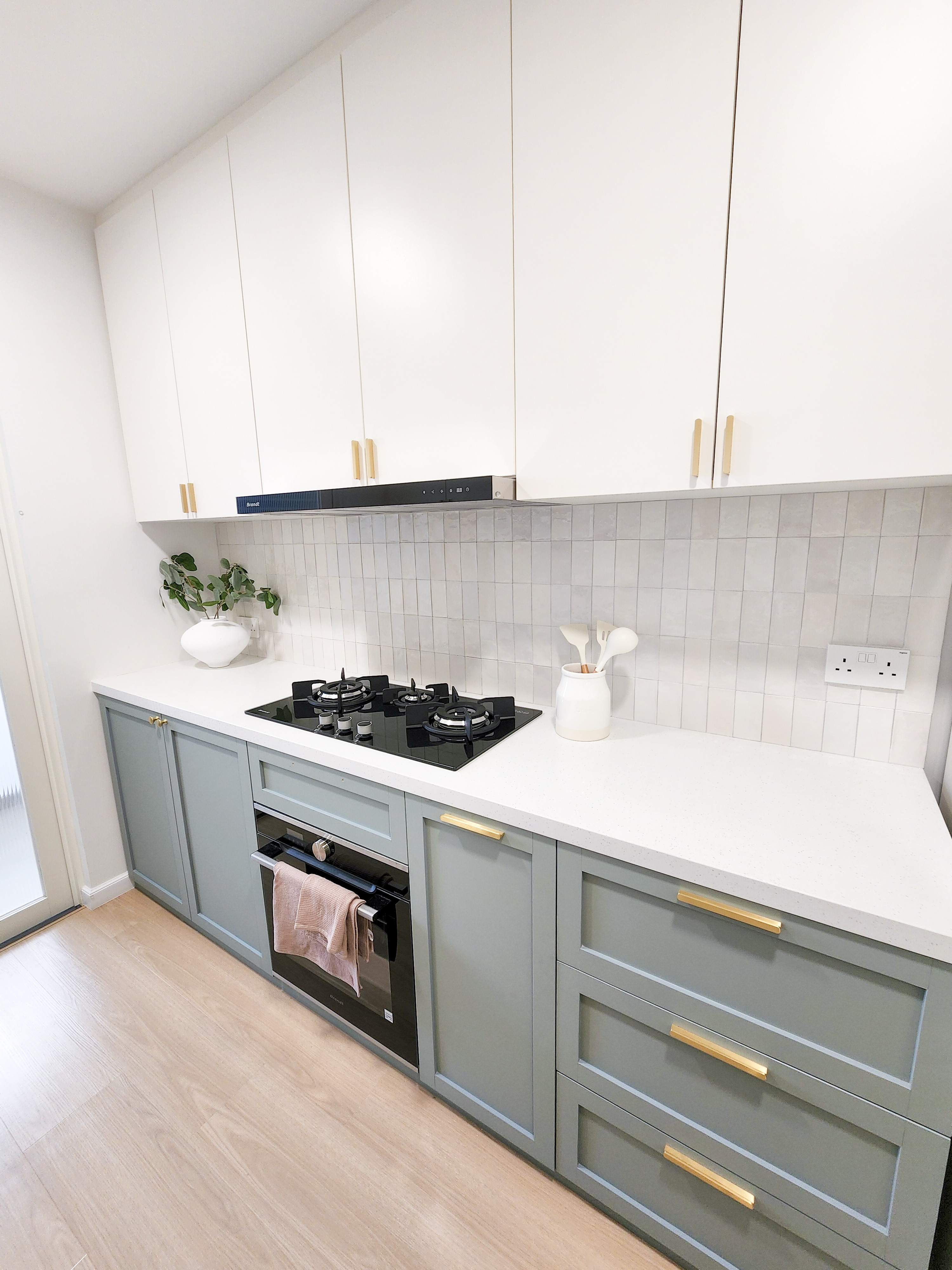 Farmhouse inspired kitchen built from scratch - White kitchen cabinetry, light gray countertops, black stovetop, white tiled