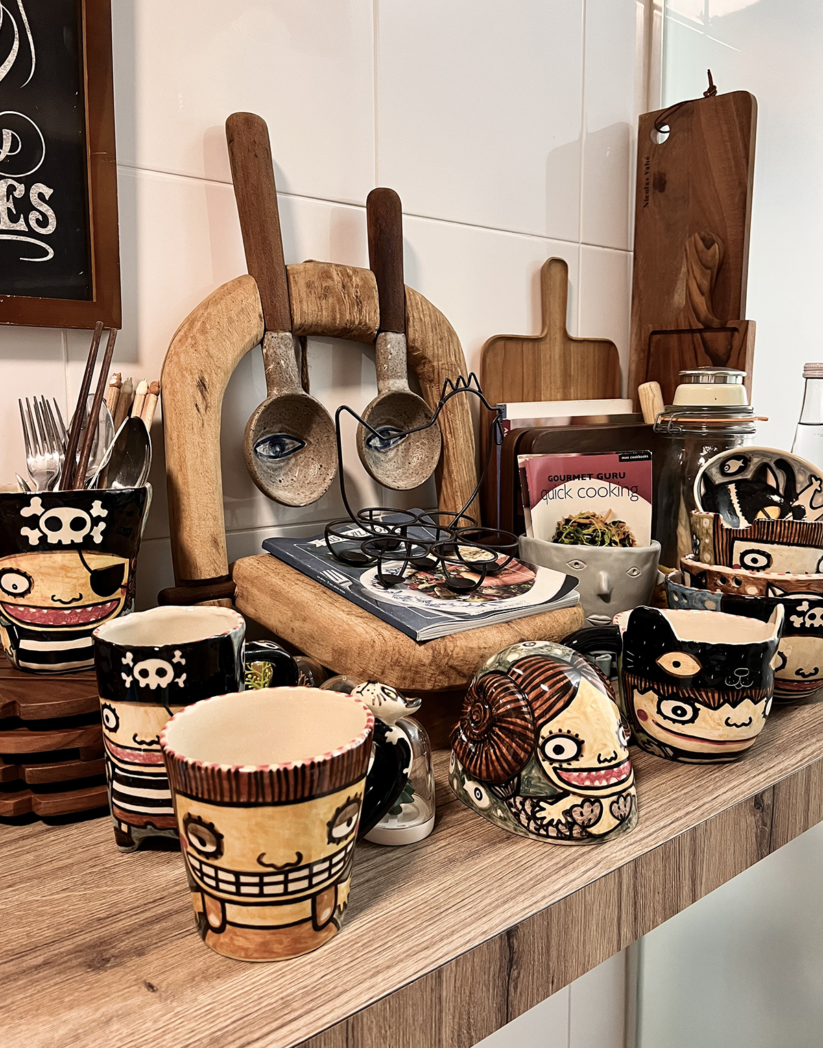 Count Your Calories In This Homey Kitchen - mug, kitchen counter, ceramic mug, pirate-themed mug, glasses, wooden utensils