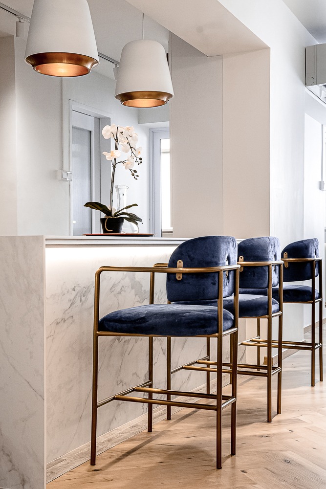 Creating a private dining kitchen space at home - modern bar area, stylish bar stools, blue velvet chairs, marble counter