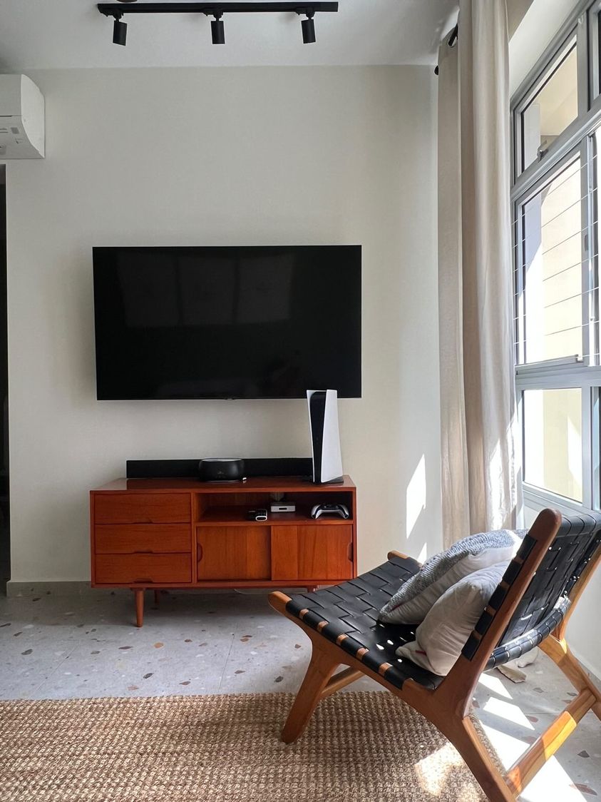 Bold green wall to brighten the space - Modern living room, minimalist decor, large flat-screen TV, wooden entertainment
