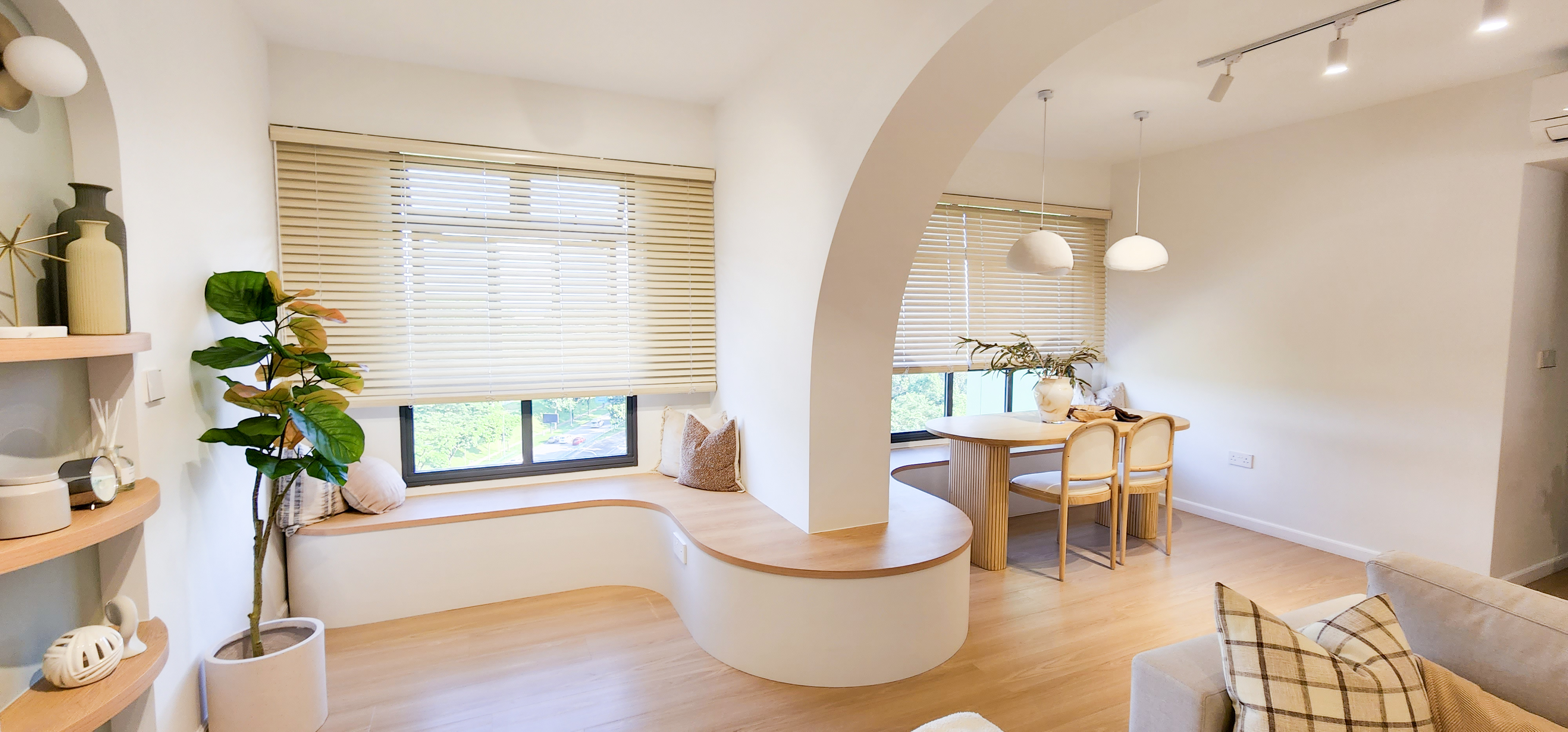 Curves & more - Modern minimalist living room, cozy seating area, large window with blinds, soft natural light, wooden