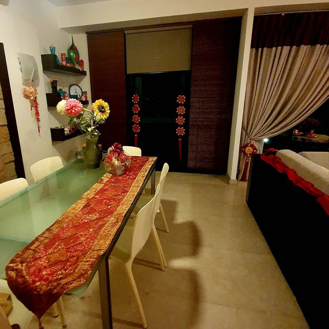 Grandeur and porcelain - glass dining table, red and gold tablecloth, white chairs, modern decor, festive decorations