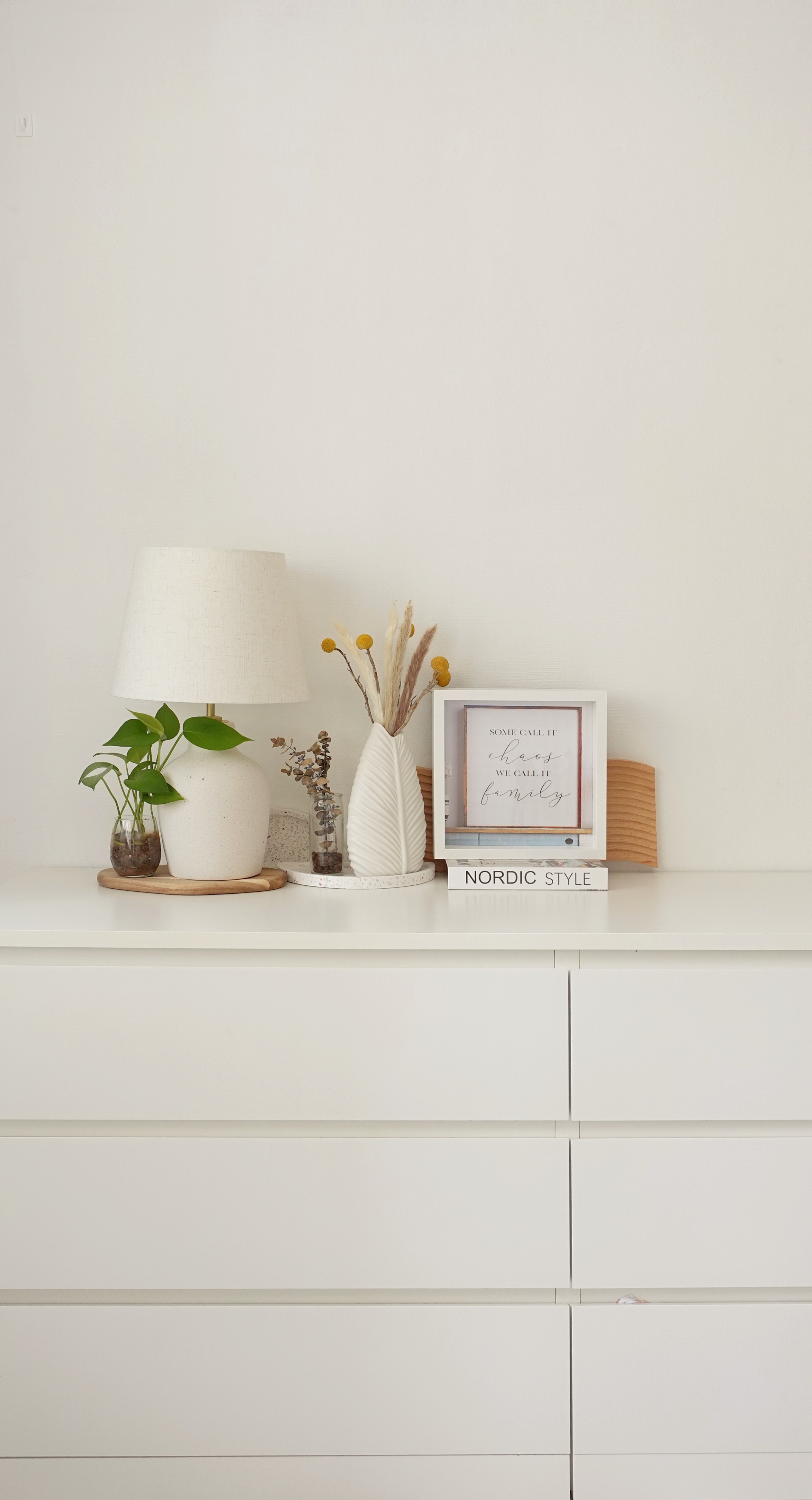 Scandinavian themed Living Room - White minimalist decor, modern art piece, Scandinavian style, white vase with green plant