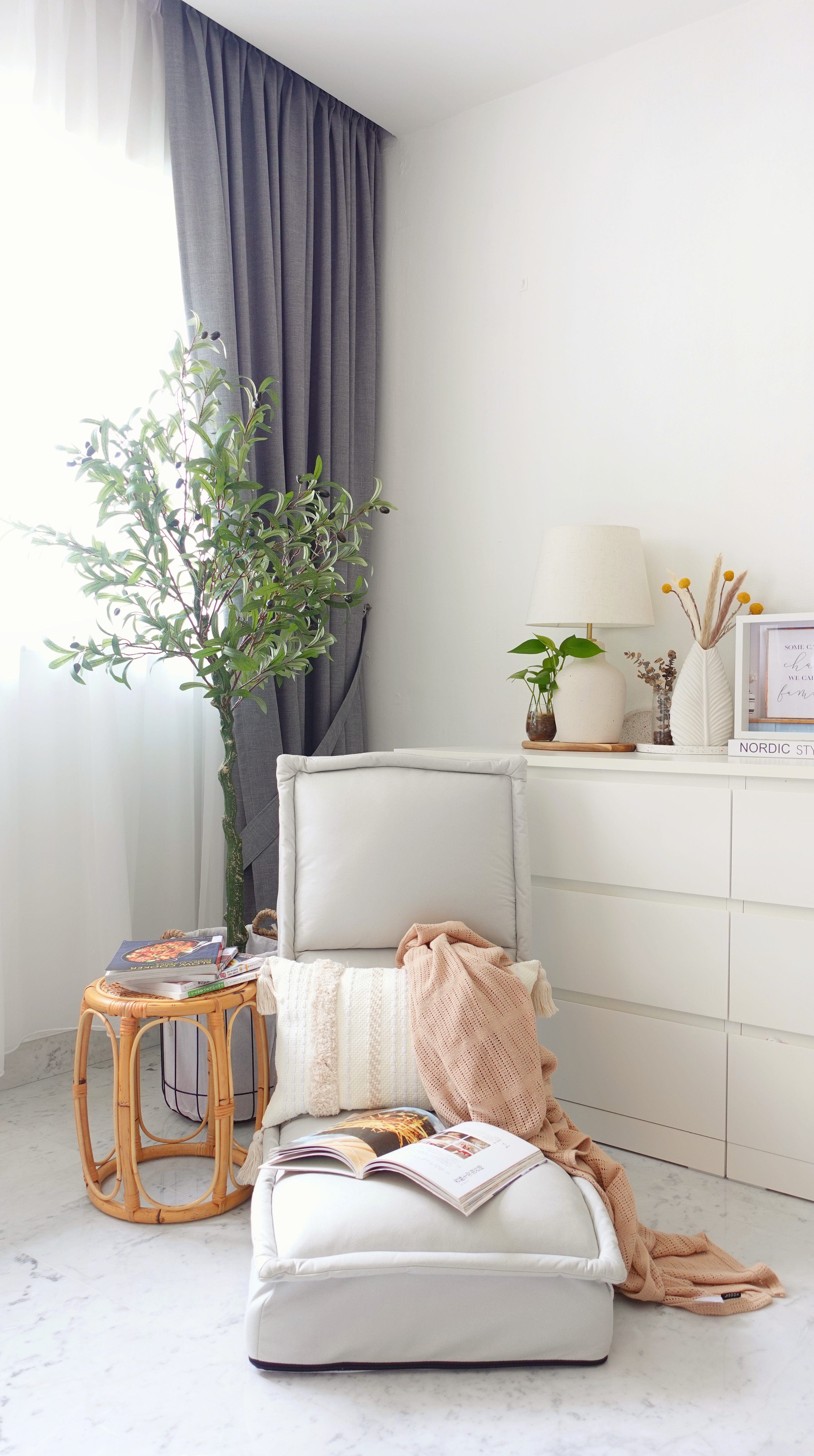 Scandinavian themed Living Room - White modern living room, minimalist decor, cozy seating area, light gray armchair, beige
