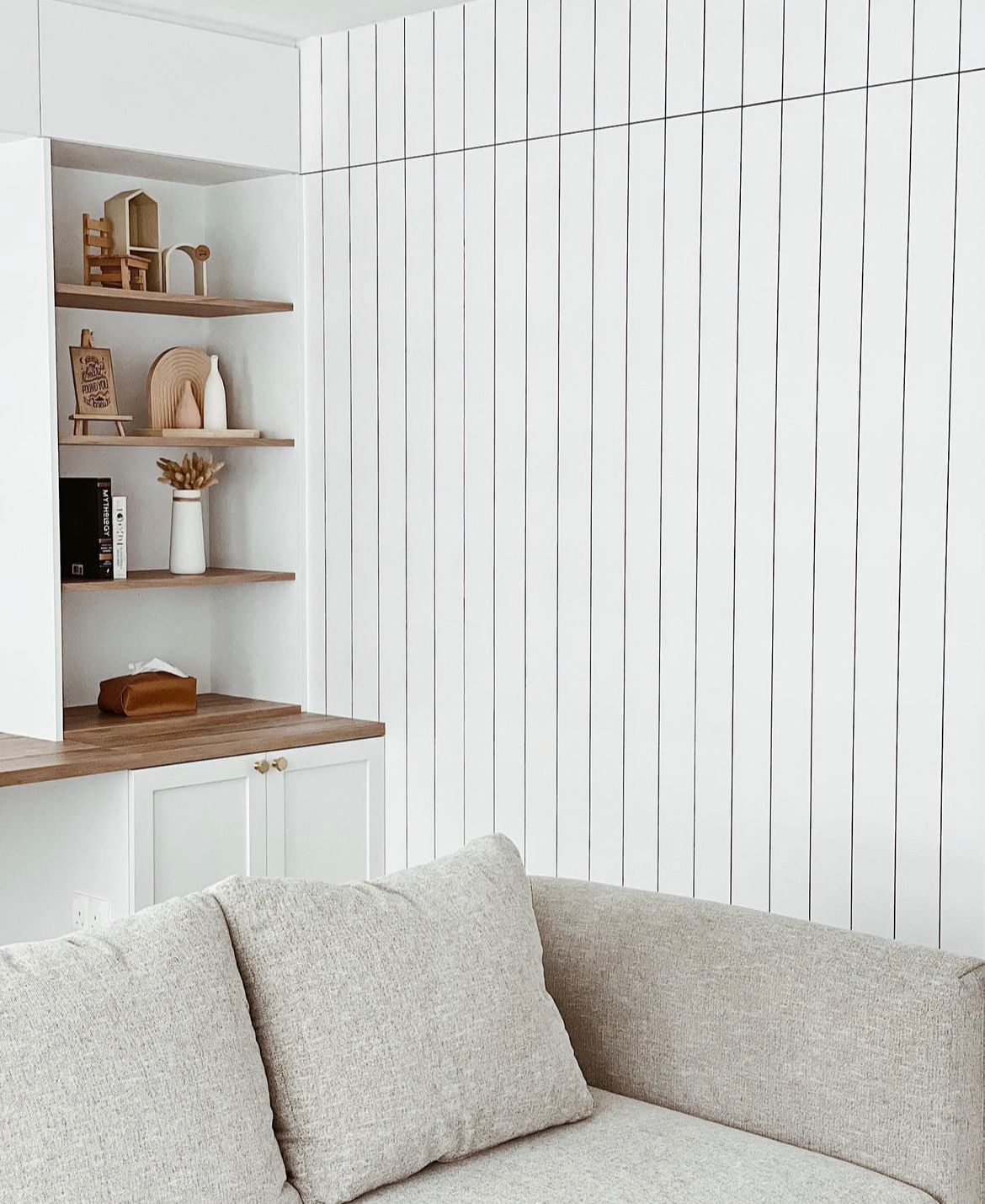 Living room with minimal but not-so-simple decor  - White vertical panel wall, minimalist interior design, light beige sofa
