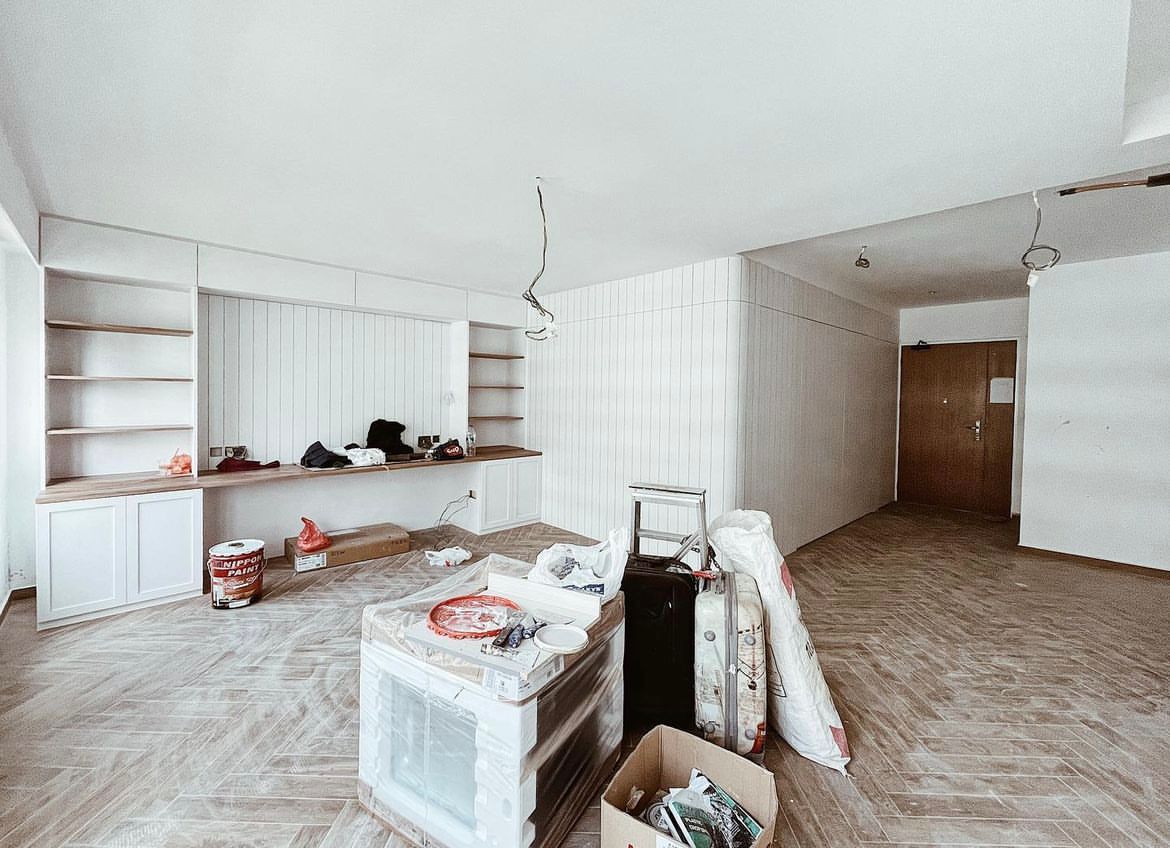 Living room with minimal but not-so-simple decor  - Floor tiles, white walls, open shelves, wooden cabinets, scattered items