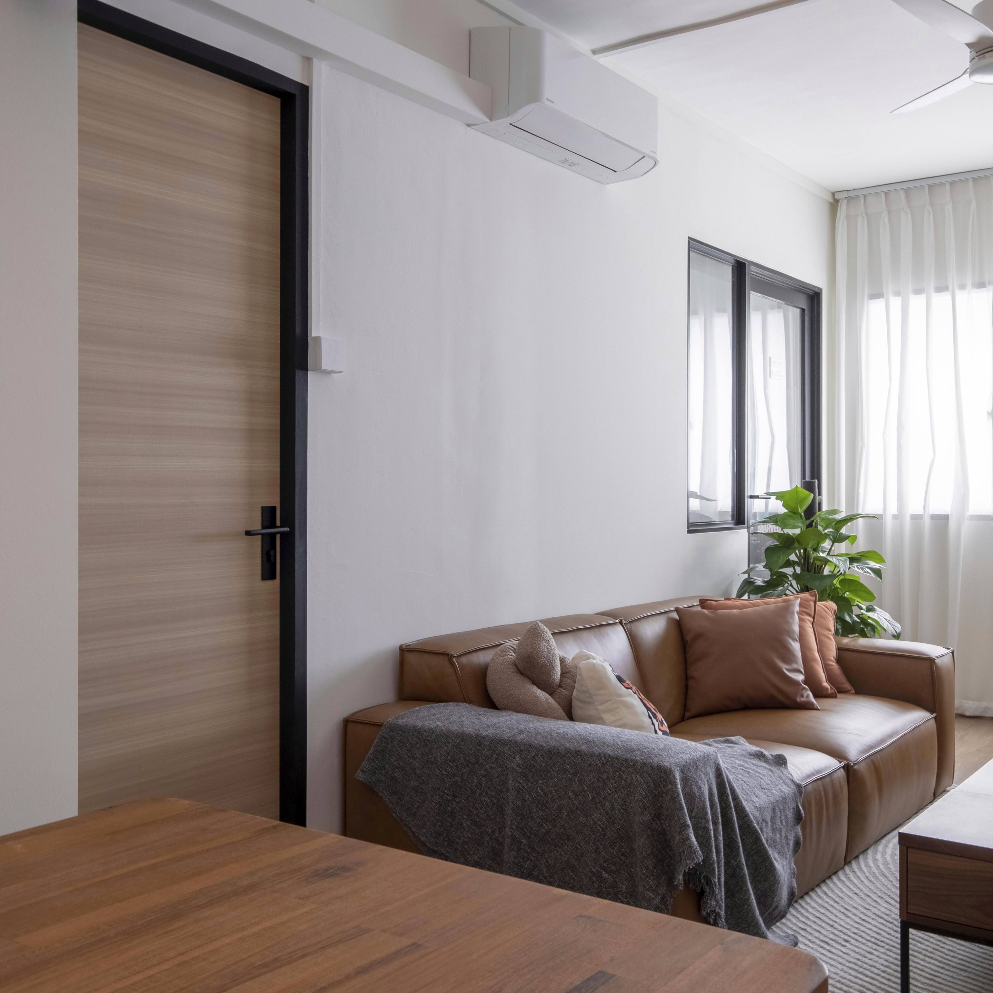 A place where we feel totally a ease - Modern living room with brown leather sofa, gray throw blanket, wooden coffee table