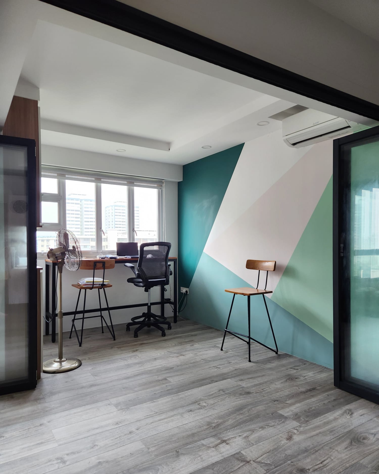 A versatile, multi-purpose home office - study space - Modern workspace with ergonomic chair and fan, sleek desk with dual