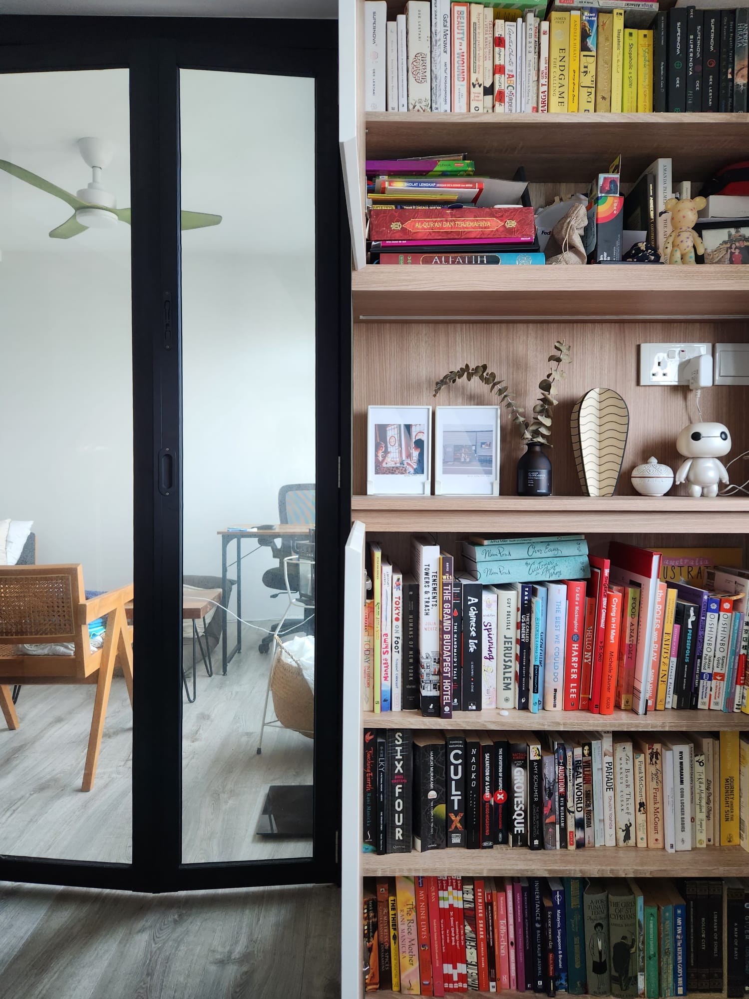A versatile, multi-purpose home office - study space - Wooden bookshelf, books, diverse titles, neatly organized, modern