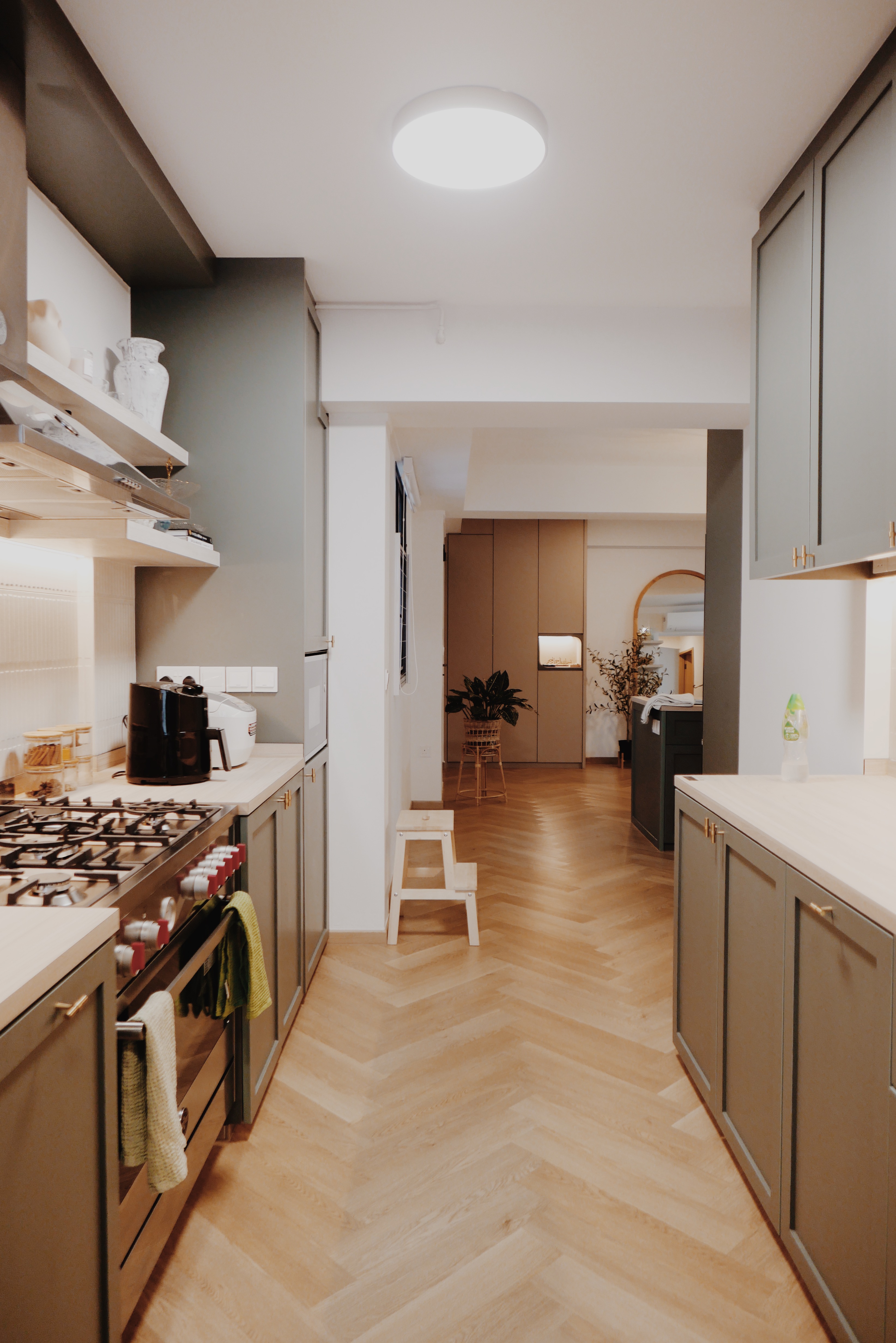 Favourite Part of Our Home! - Modern kitchen with light beige cabinets, white countertops, and wooden herringbone flooring.