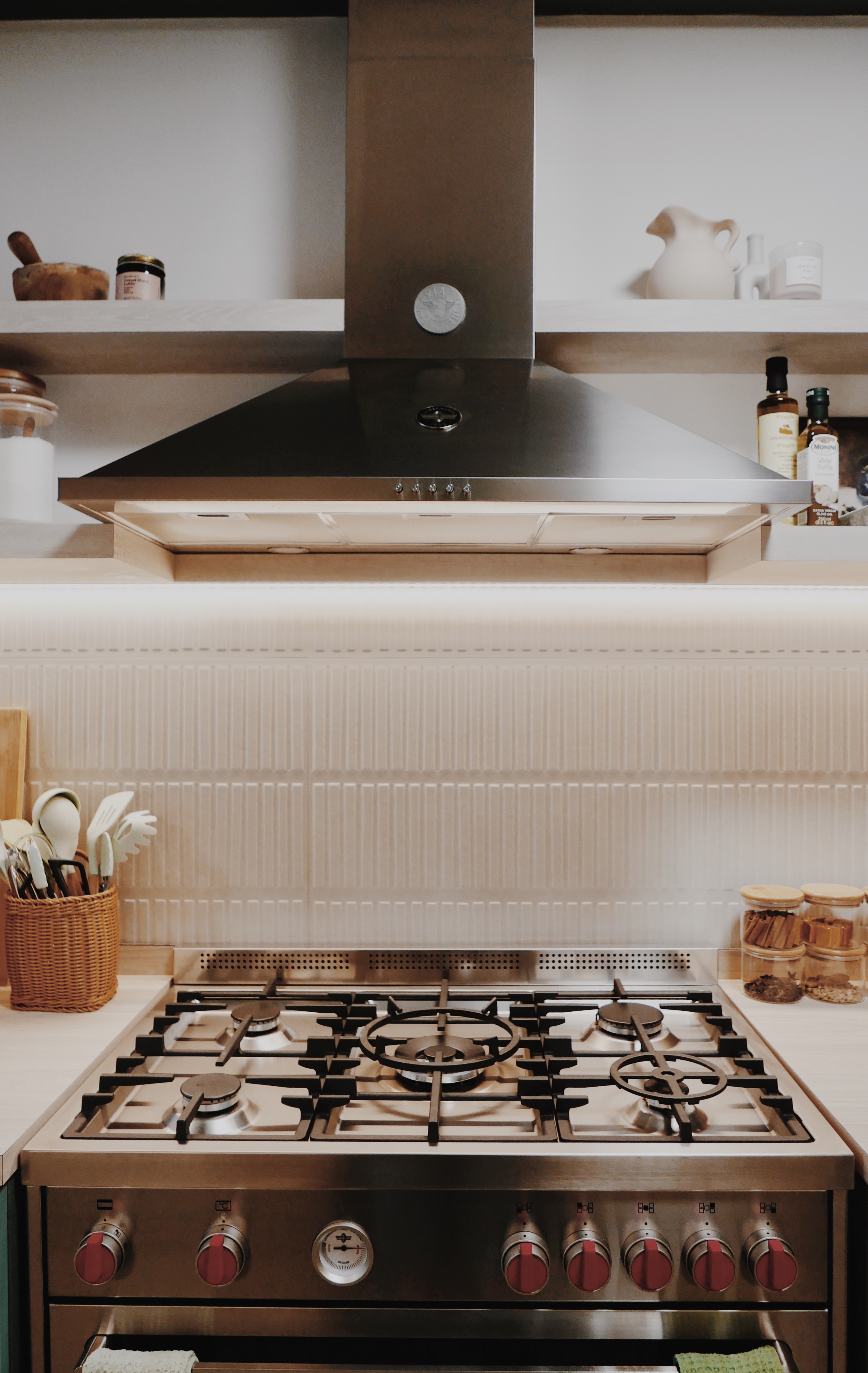 Favourite Part of Our Home! - Modern kitchen with stainless steel appliances, gas stove with red knobs, under-cabinet