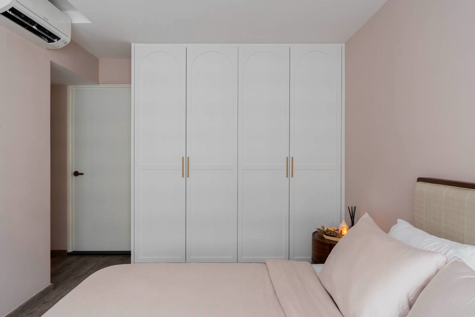 Our master bedroom is kept to the necessities - White wardrobe with gold handles, pink bedding, minimalist design, modern