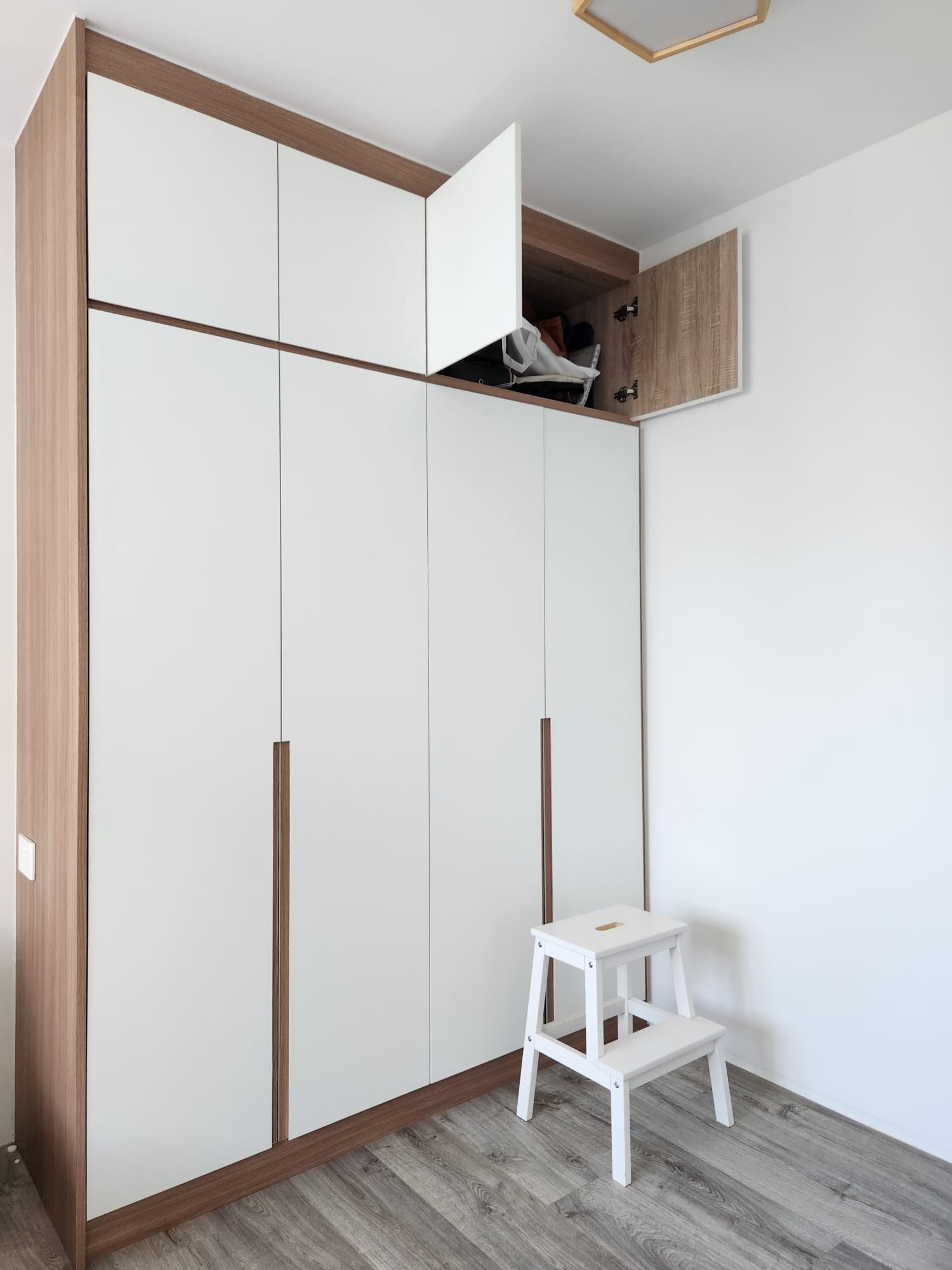 A warm and cozy bedroom to come home to - Wooden wardrobe with sliding doors, minimalist design, white and brown color