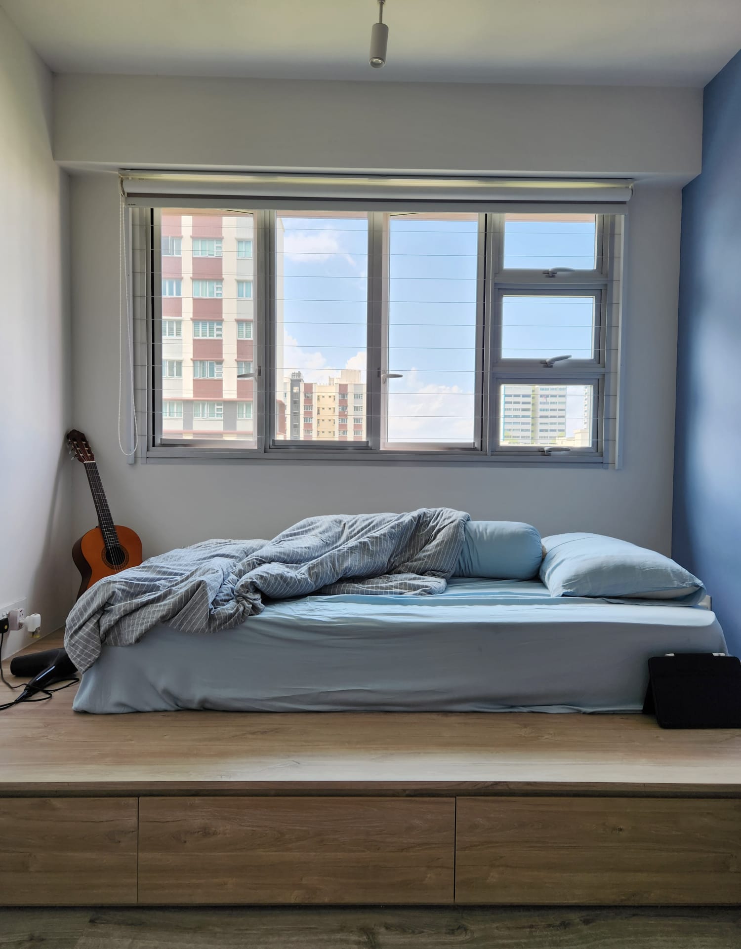 A warm and cozy bedroom to come home to - Modern minimalist bedroom, cozy bed, blue bedding, light blue pillows, wooden