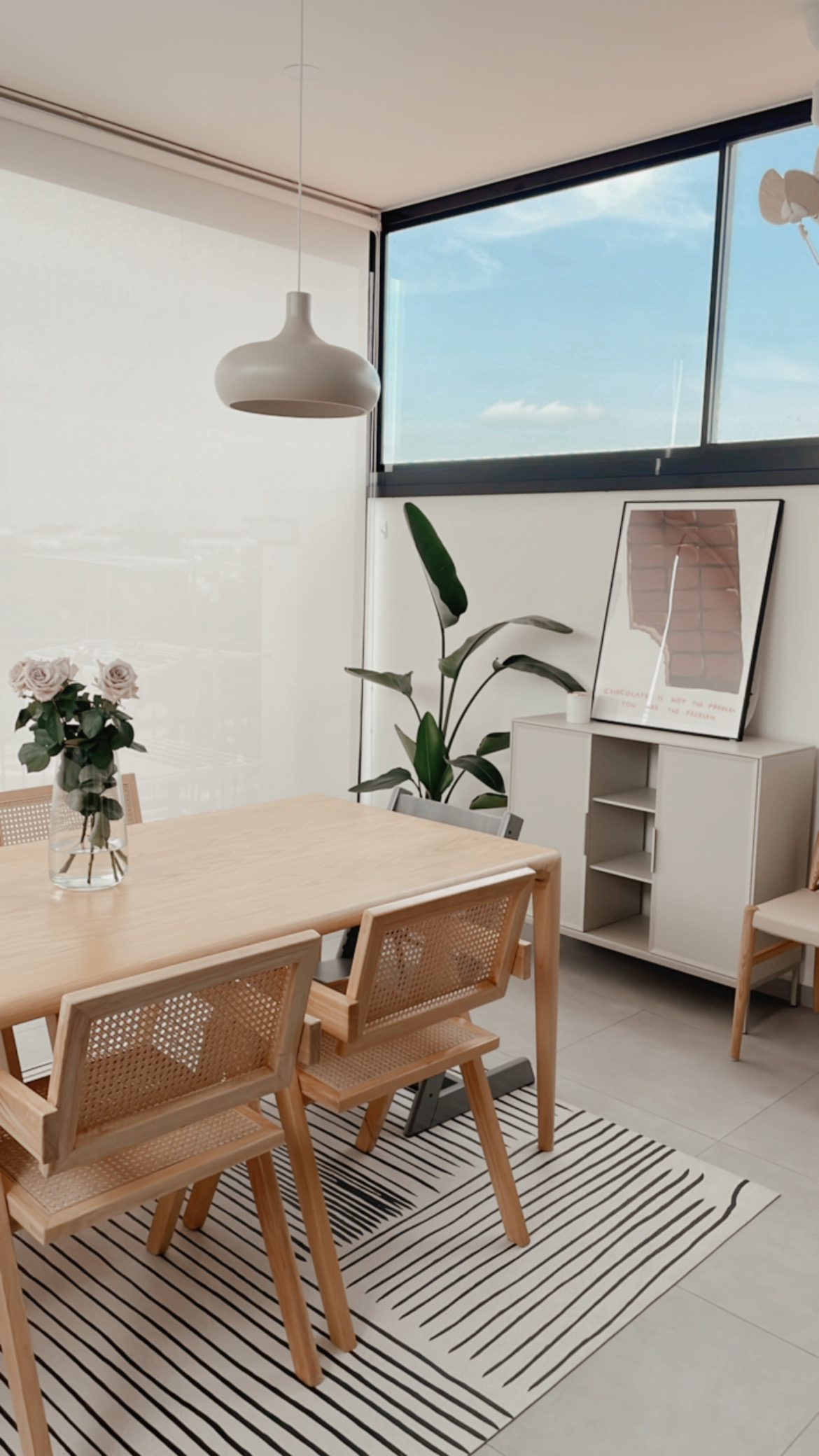 Our Minimalist Kitchen is a conversation starter - Modern minimalist dining room, large window with blue sky, natural light