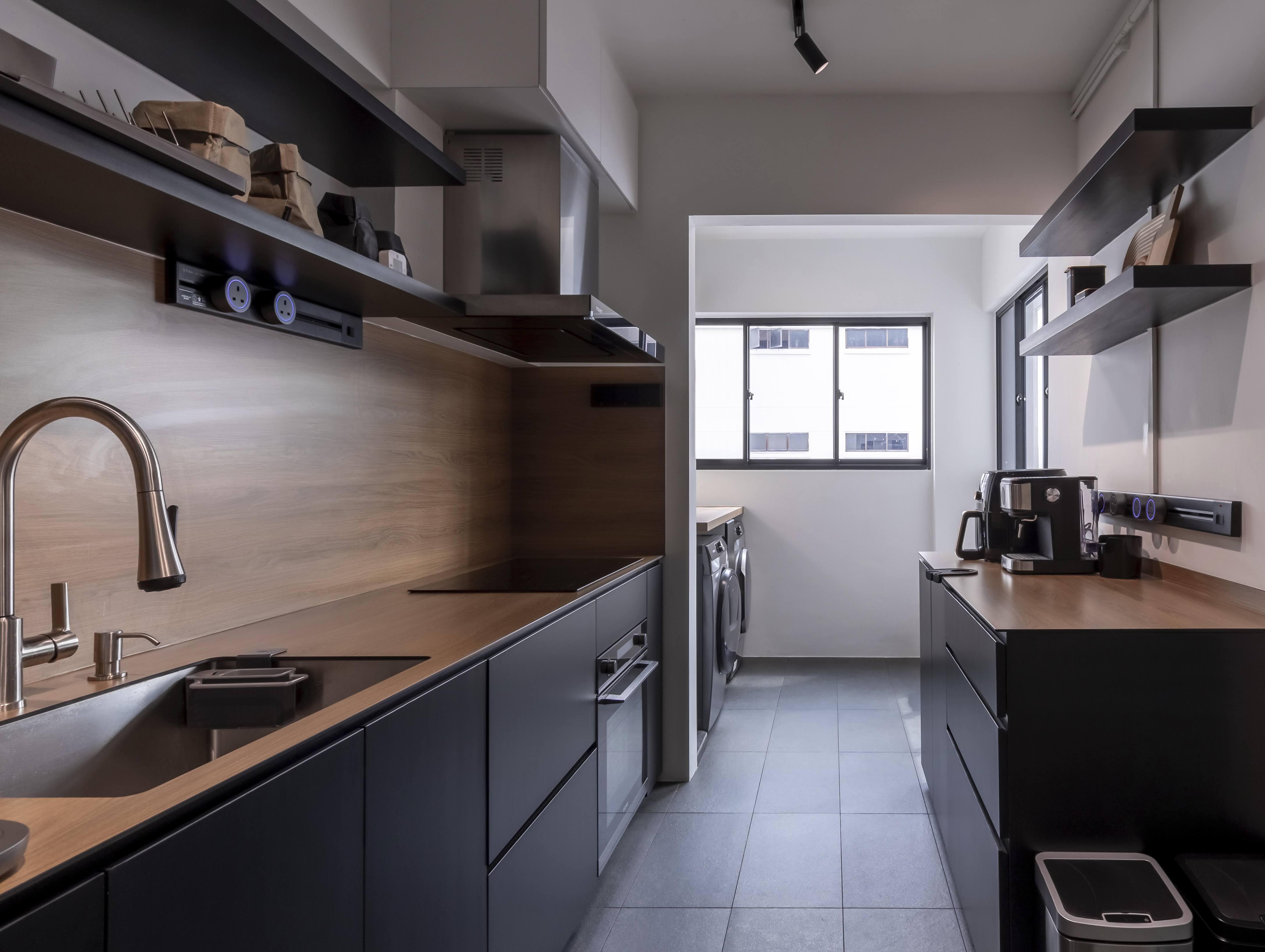 A Kitchen With Wooden Tones & Black Elements - Modern kitchen with sleek design, stainless steel appliances, black cabinetry