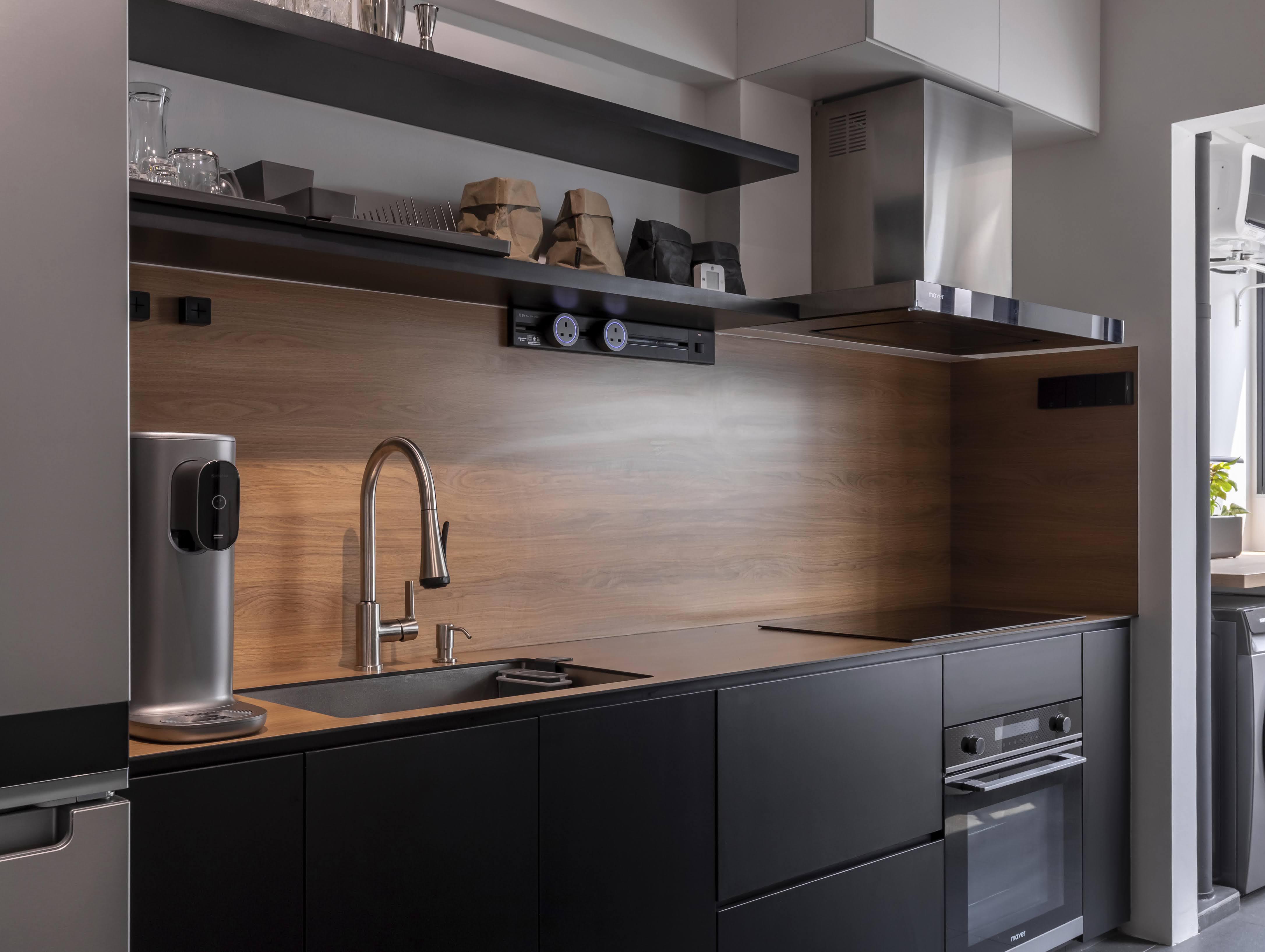 A Kitchen With Wooden Tones & Black Elements - Modern kitchen with sleek design, stainless steel appliances, wooden cabinets