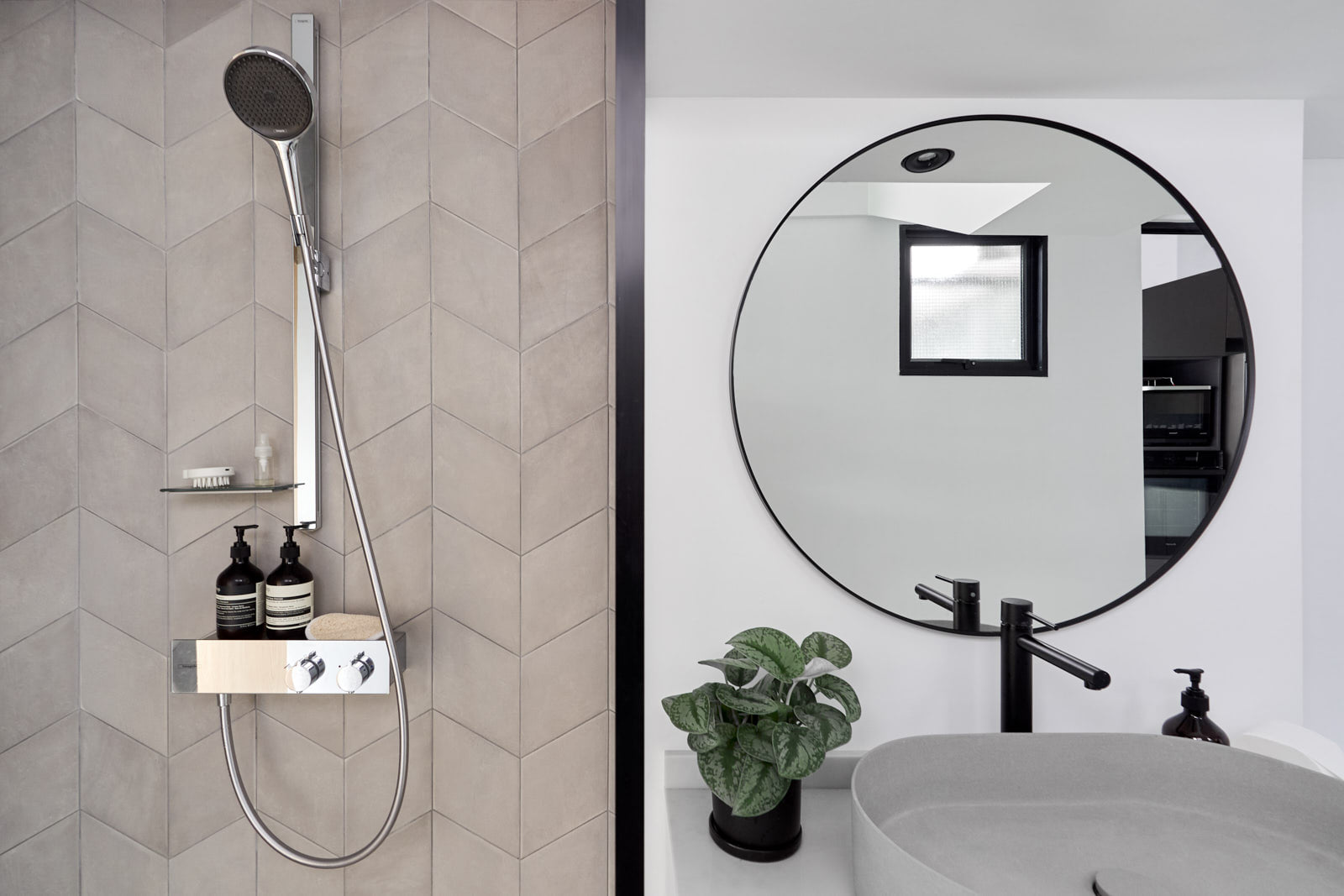A hotel-like bathroom - Shower with integrated showerhead and soap dispensers, beige tiled wall, modern design, black and