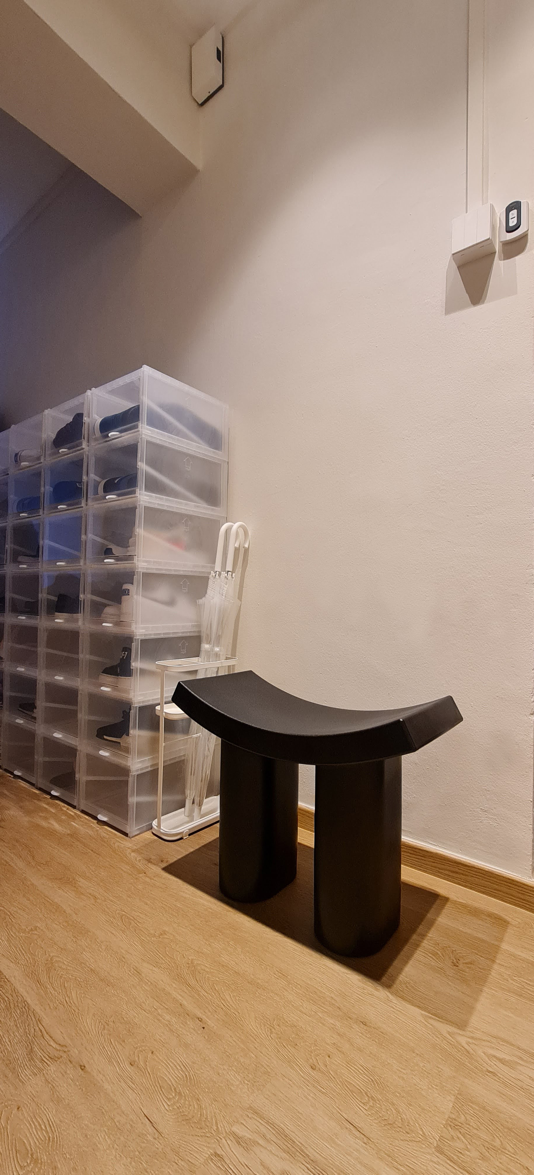 No more searching for our soles - Clear plastic shoe storage bins, modern black coffee table, minimalist design, organized