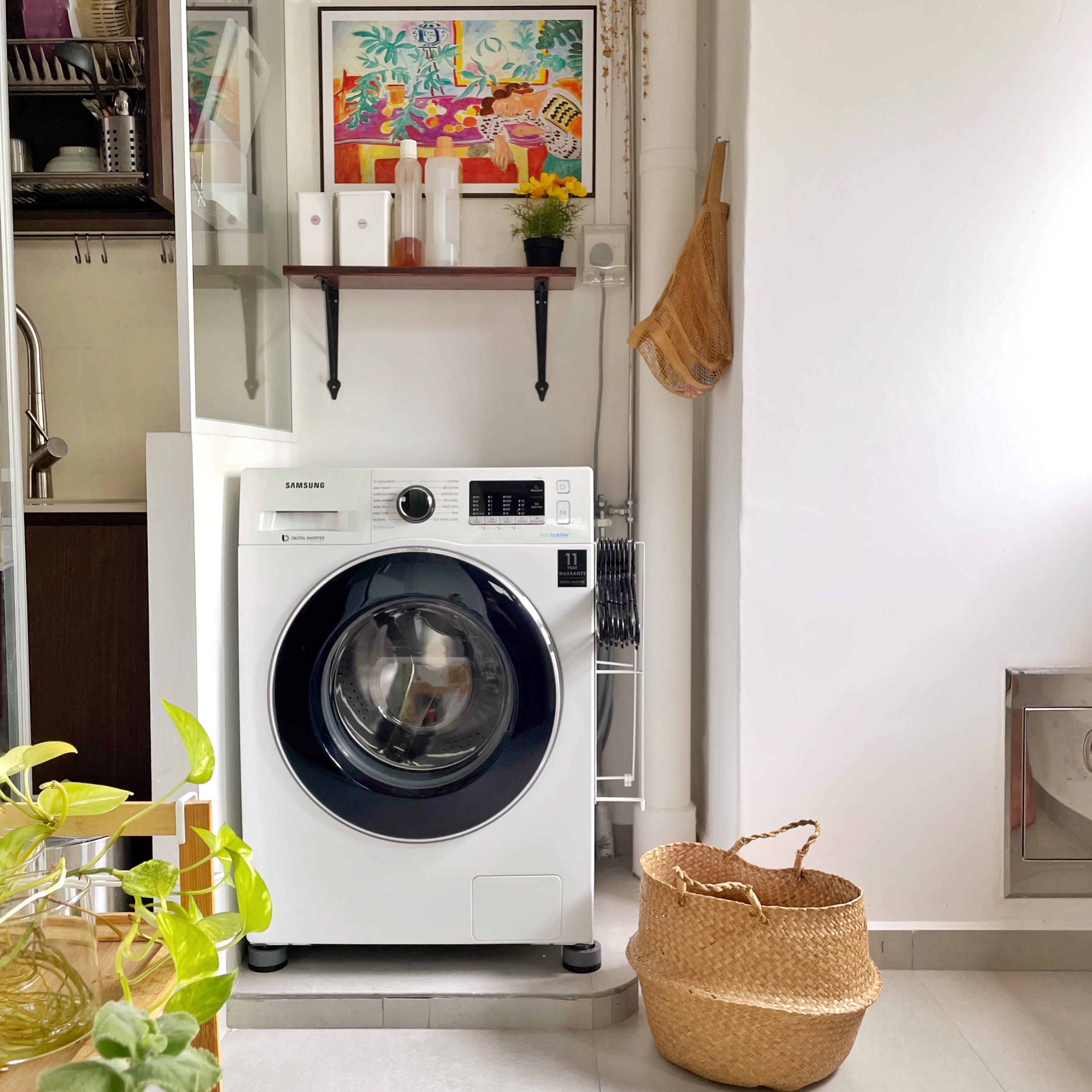 Bright, airy and lived-in. This is our home.  - Washing machine, white Samsung washing machine, modern kitchen, plant