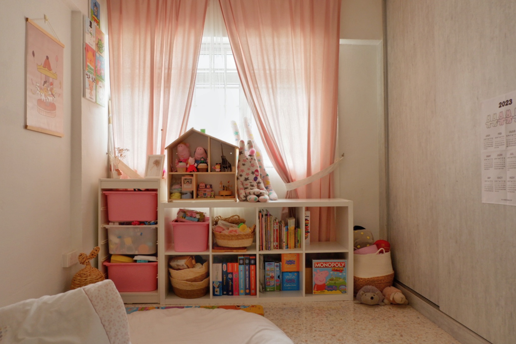 Quaint 4-Room Flat At Geylang East Renovated for <40K - Children's room with soft pink curtains, white shelves filled with