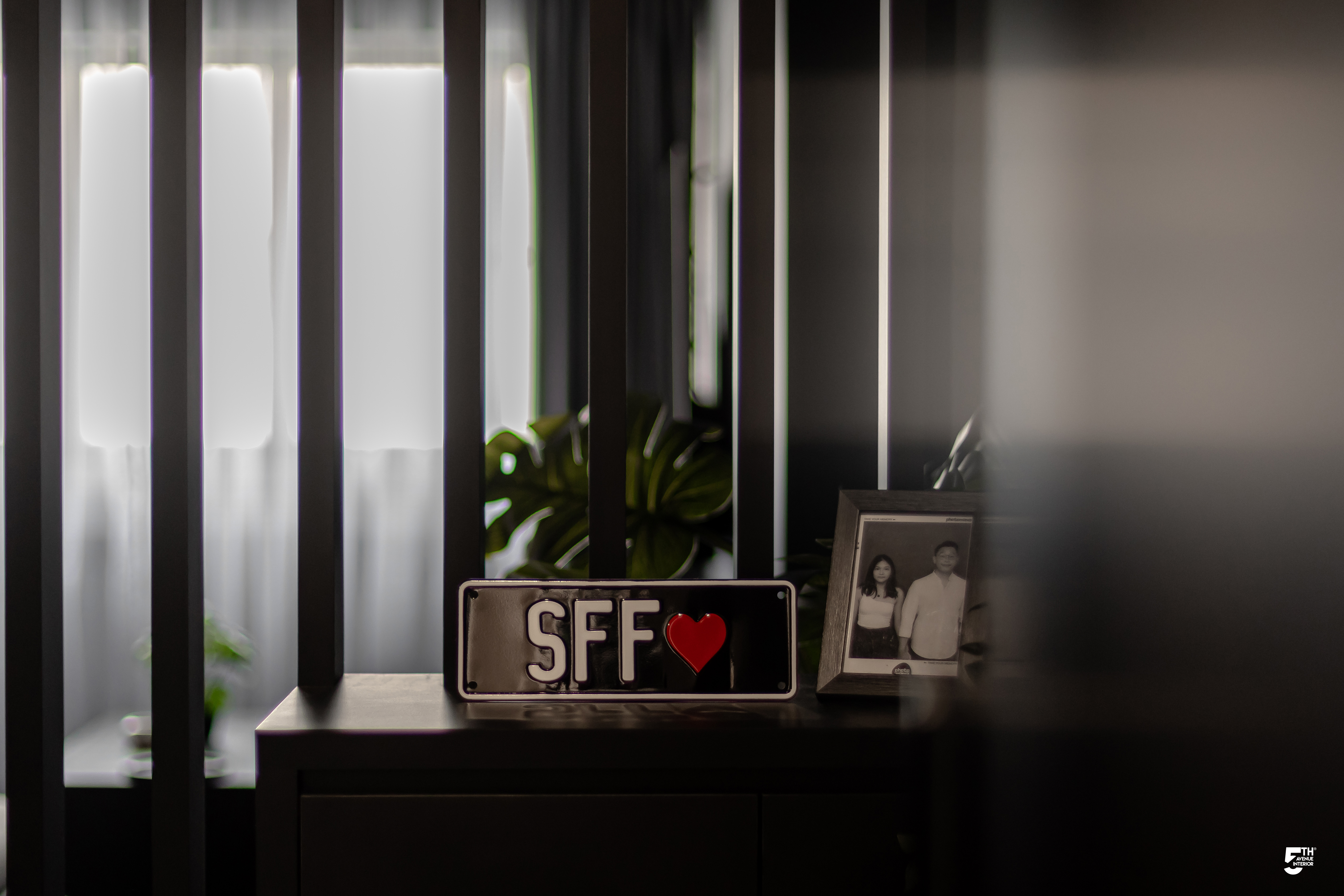 A Cosy Dark Modern Contemporary Home - SFF sign, black and white photo, framed family portrait, indoor setting, vertical