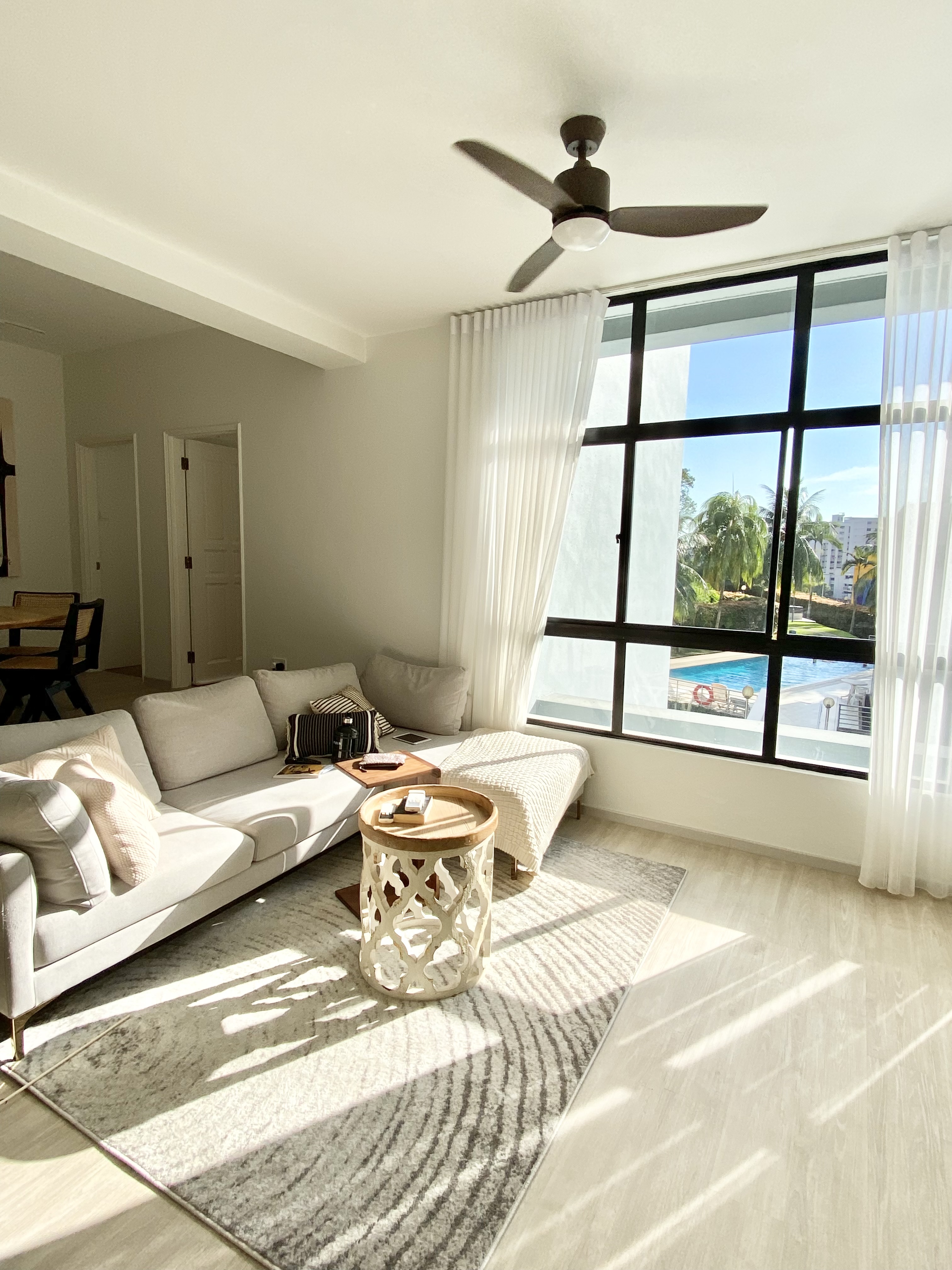 Welcome to MistyHaus, a 30 year old renovated home - Sunlight streaming into living room, modern design, beige sofa