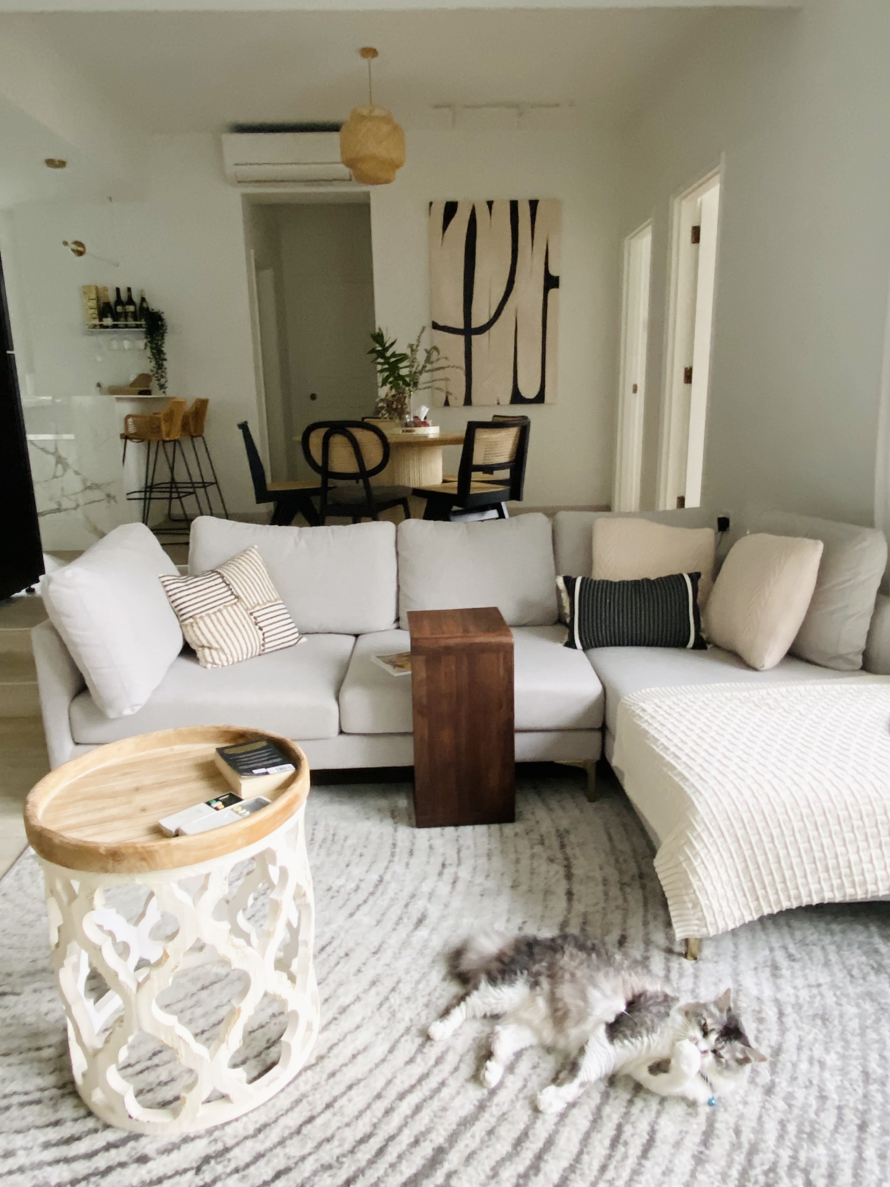 Welcome to MistyHaus, a 30 year old renovated home - Modern living room with light gray sofa, striped and solid pillows