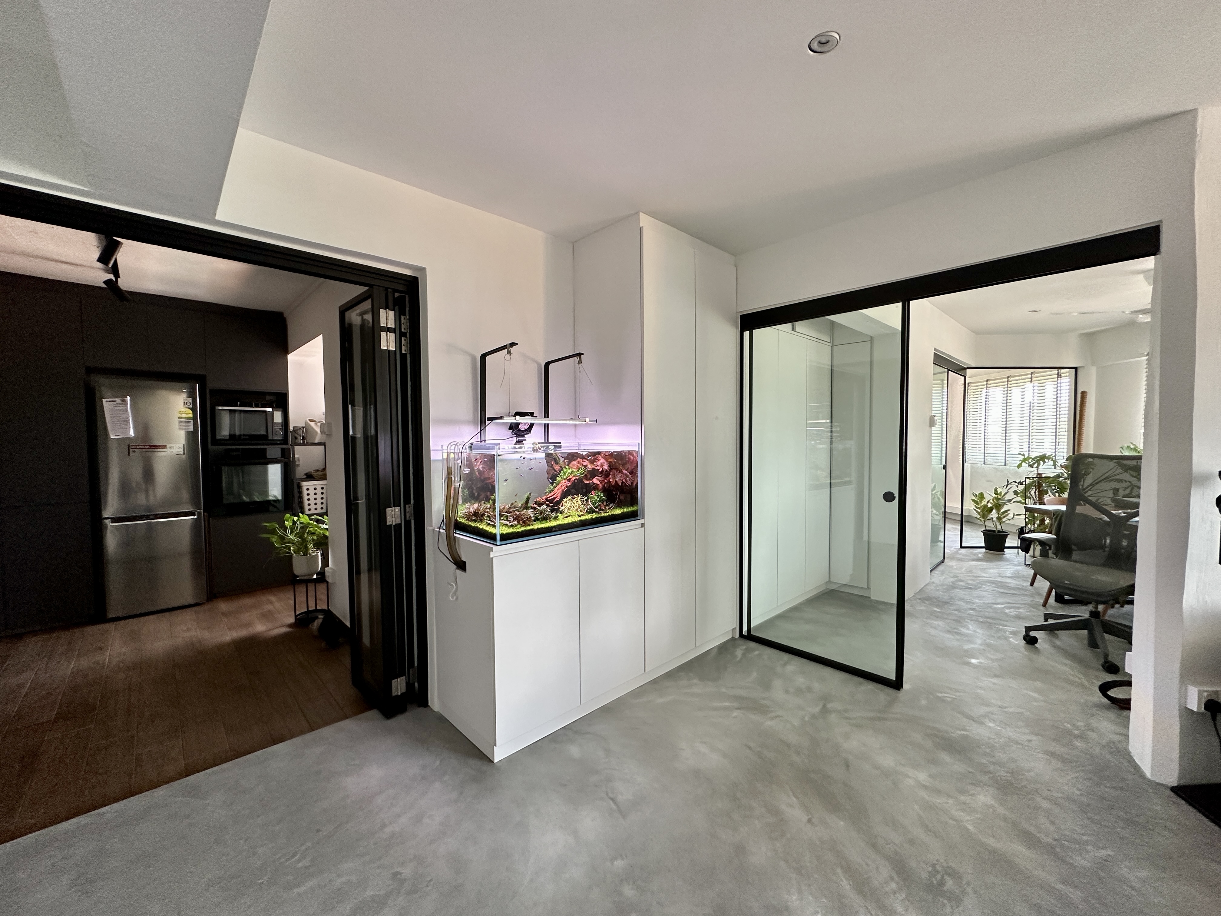 A central storage to keep the look neat - Modern kitchen with sleek design, stainless steel refrigerator, black-framed glass