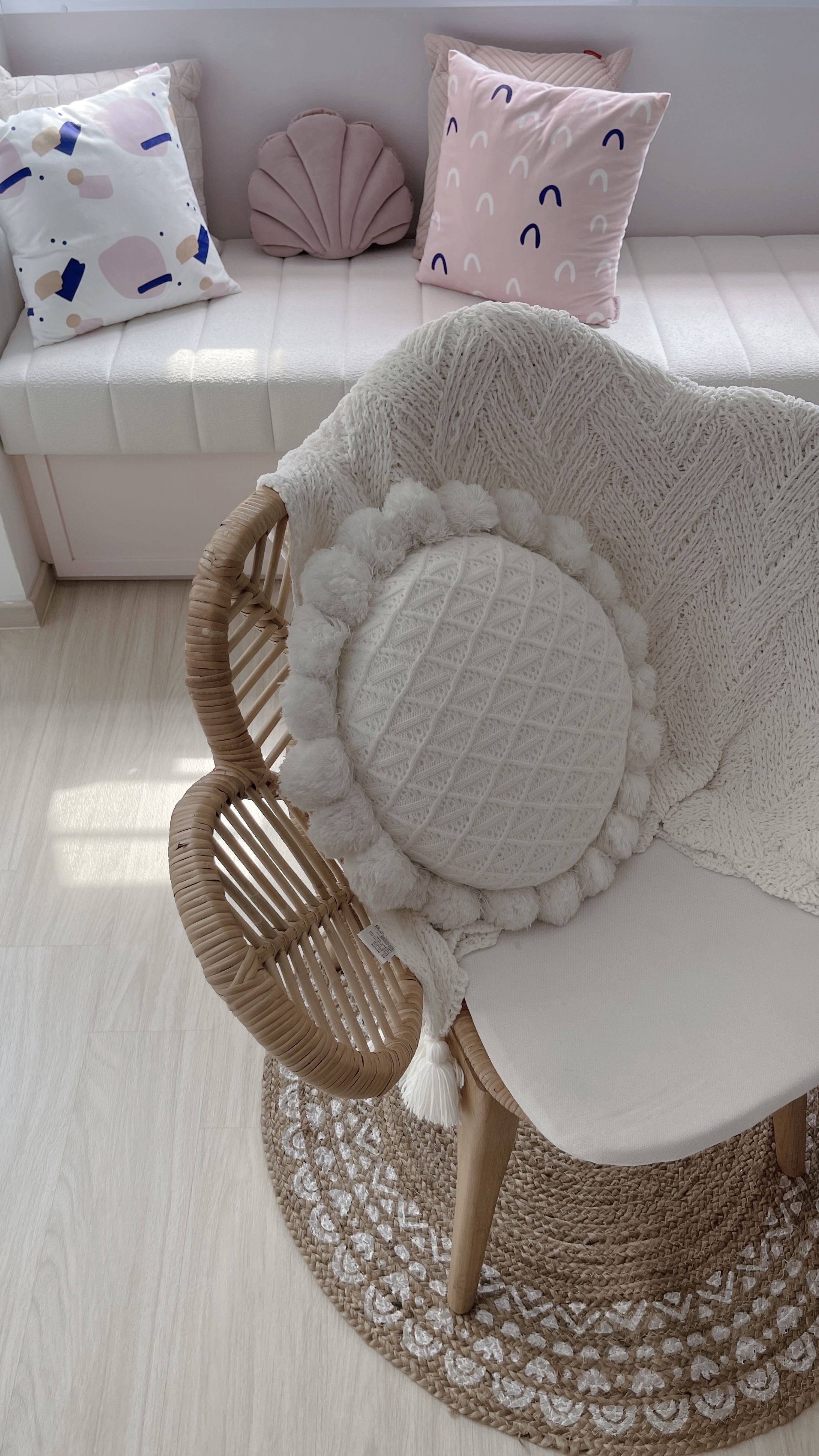 Living Room - the reset corner - Soft, pastel-colored cushions, cream-colored woven chair, fluffy white throw blanket, cozy
