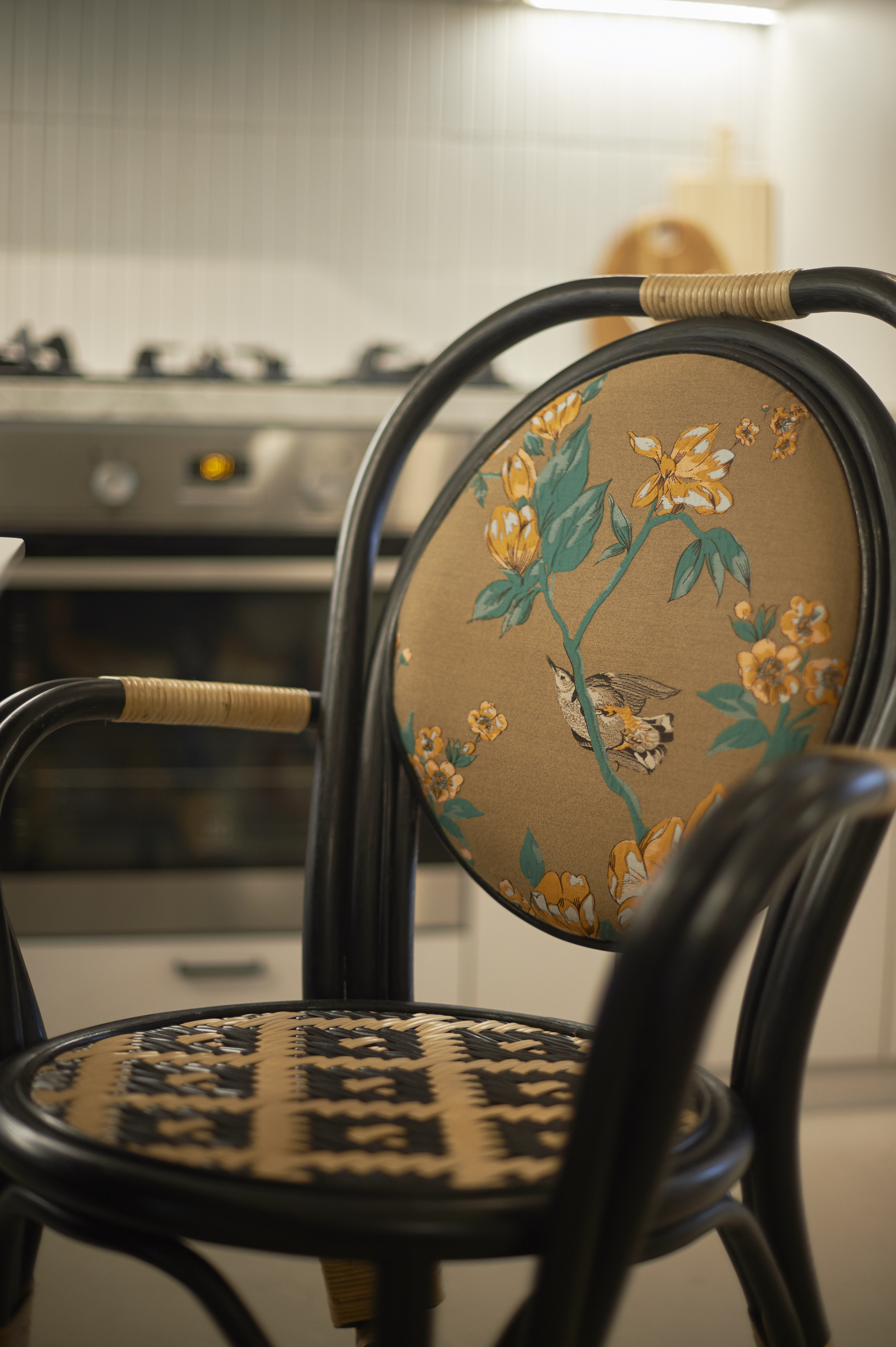 Dining room features & hidden doggy door - vintage chair, upholstered seat, floral design, bird illustration, woven armrest