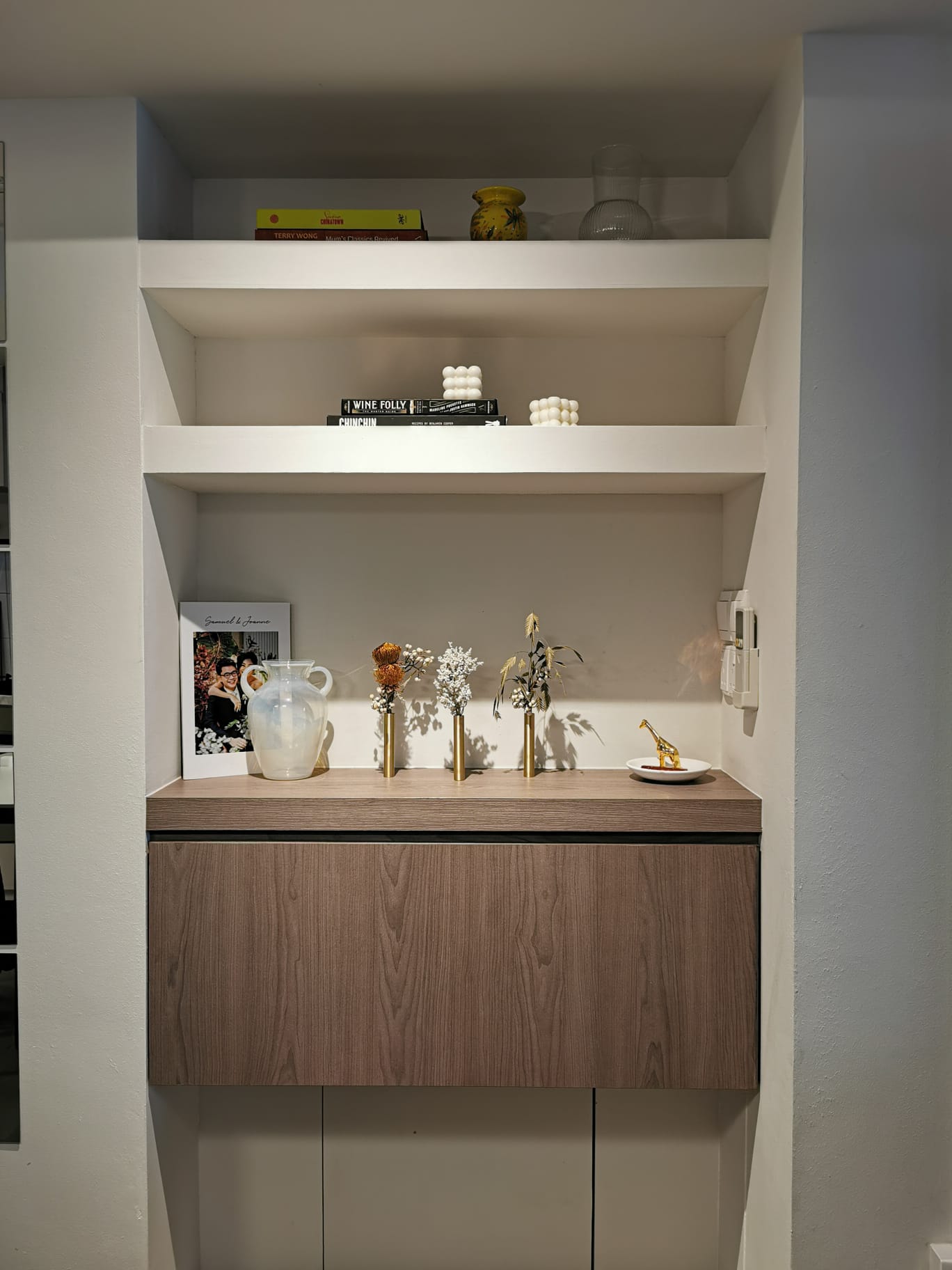 Dining room features & hidden doggy door - Wooden cabinet, minimalist design, white shelves, decorative items, framed photo