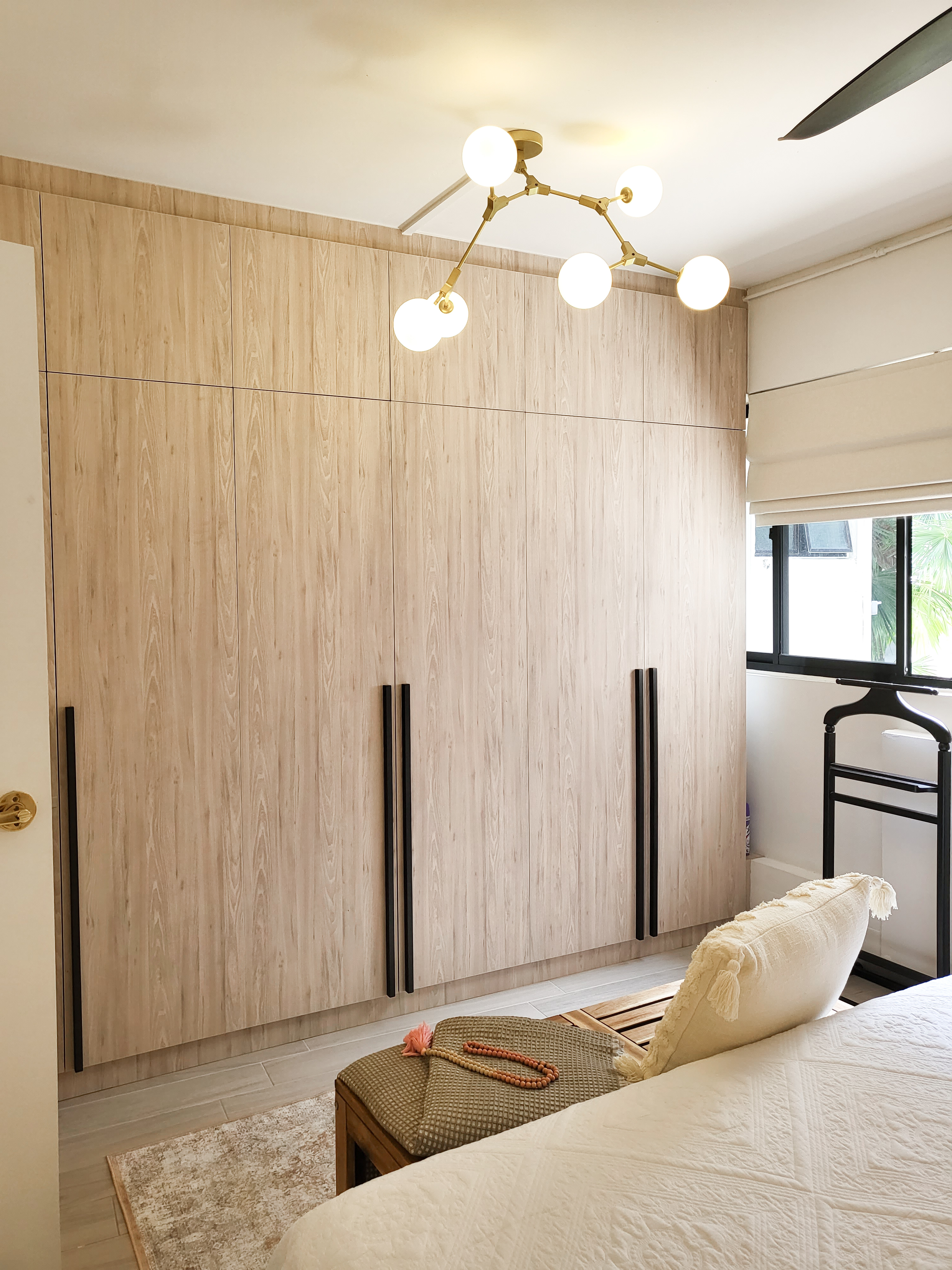 Falling in love with a romantic villa bedroom  - Wooden wardrobe with black handles, beige carpet, beige bed with prayer