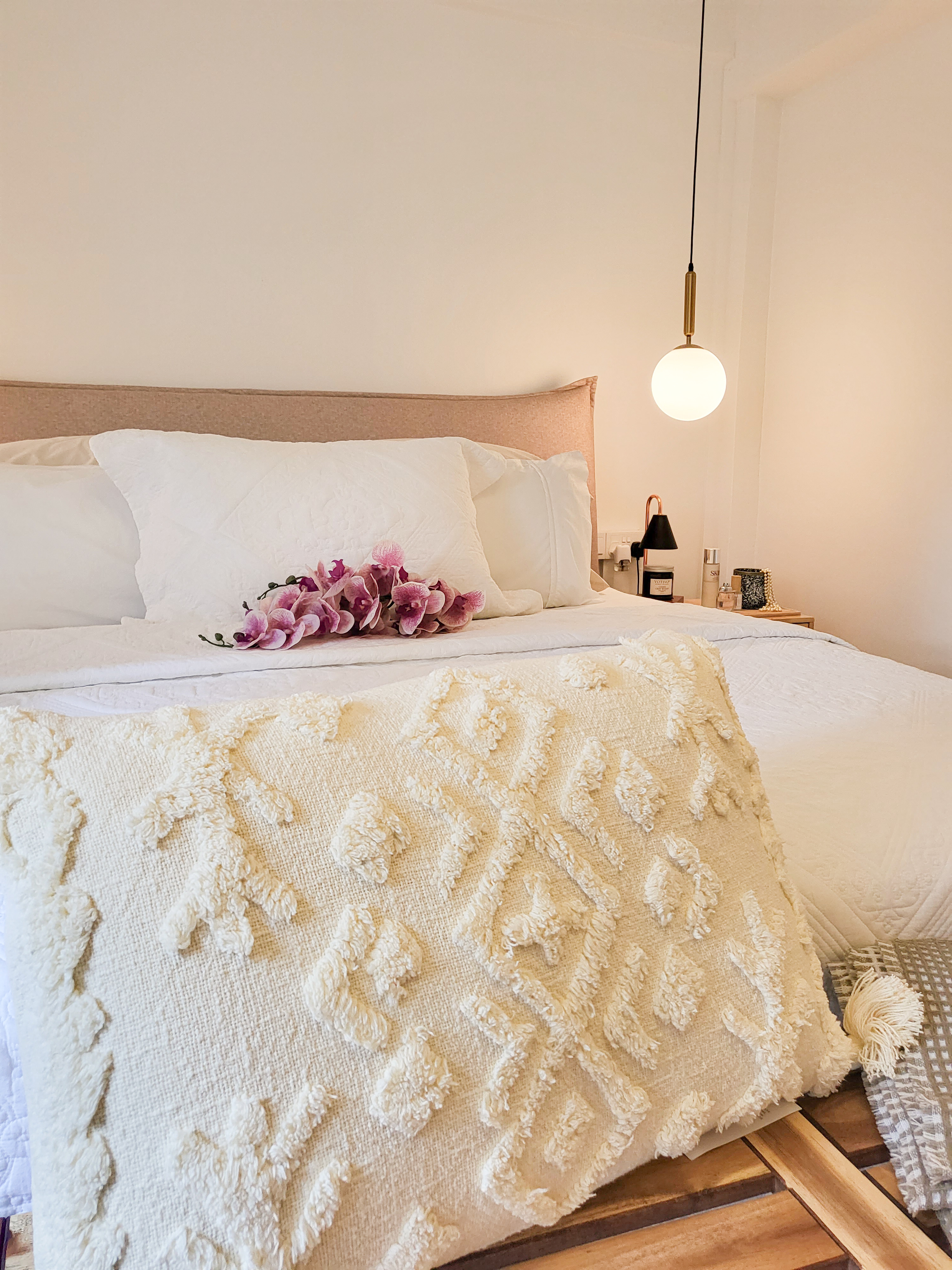 Falling in love with a romantic villa bedroom  - White and beige bedding, floral pillows, textured blanket, elegant pendant