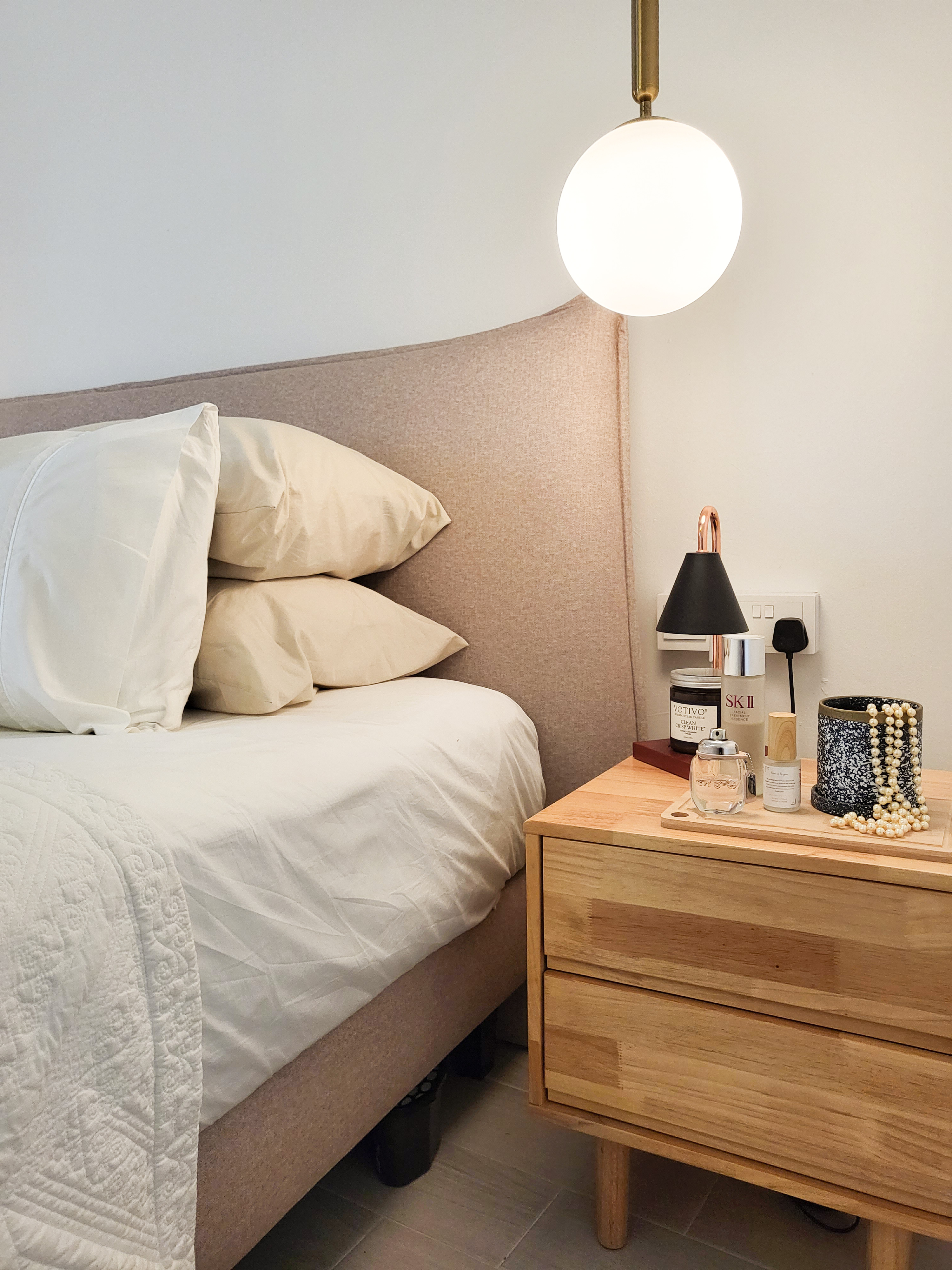 Falling in love with a romantic villa bedroom  - White bed with beige headboard, beige pillows, wooden nightstand, round