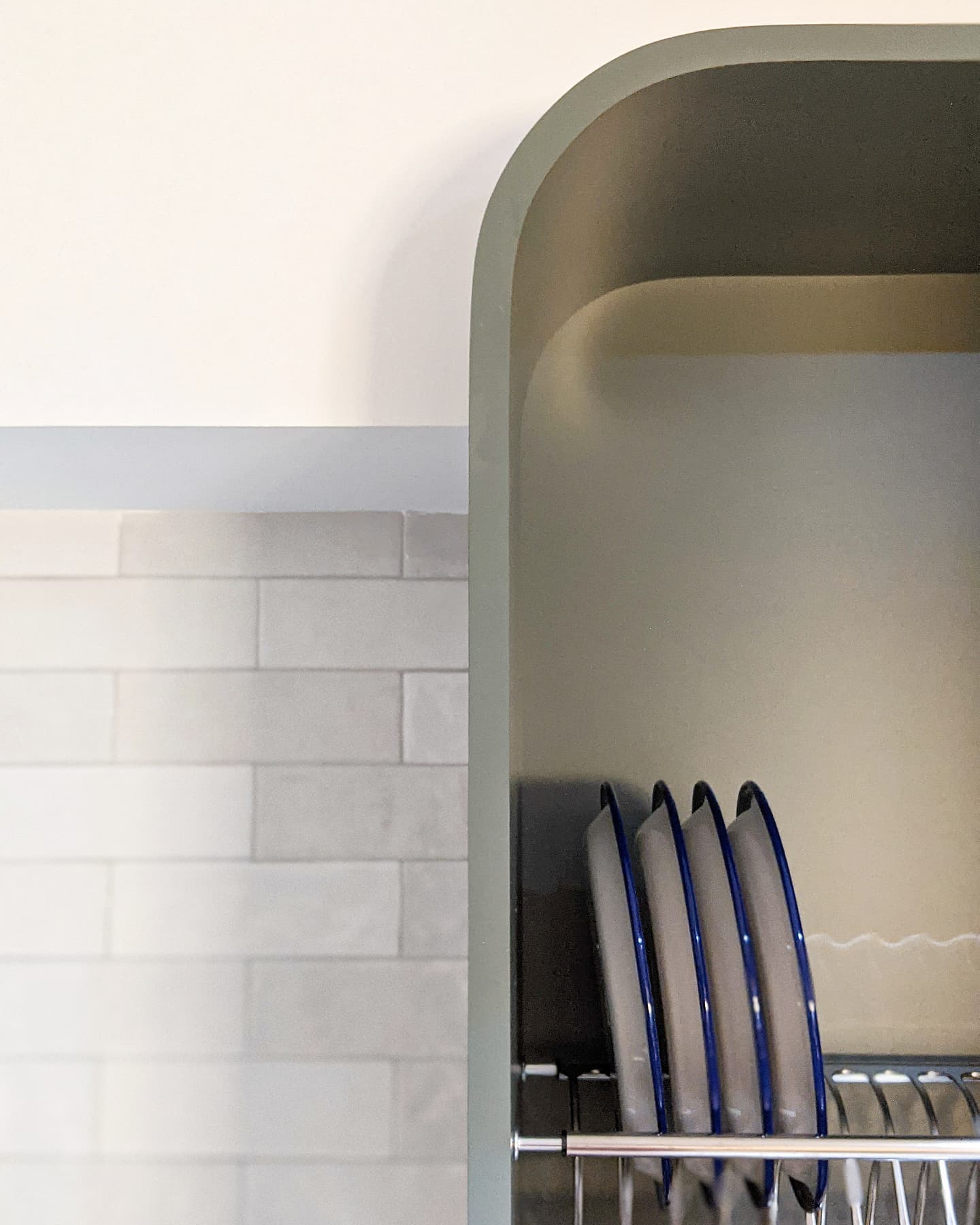 Our Kitchen | The pièce de résistance - White tiled wall, kitchen cabinet, dish rack, blue and gray plates, modern kitchen