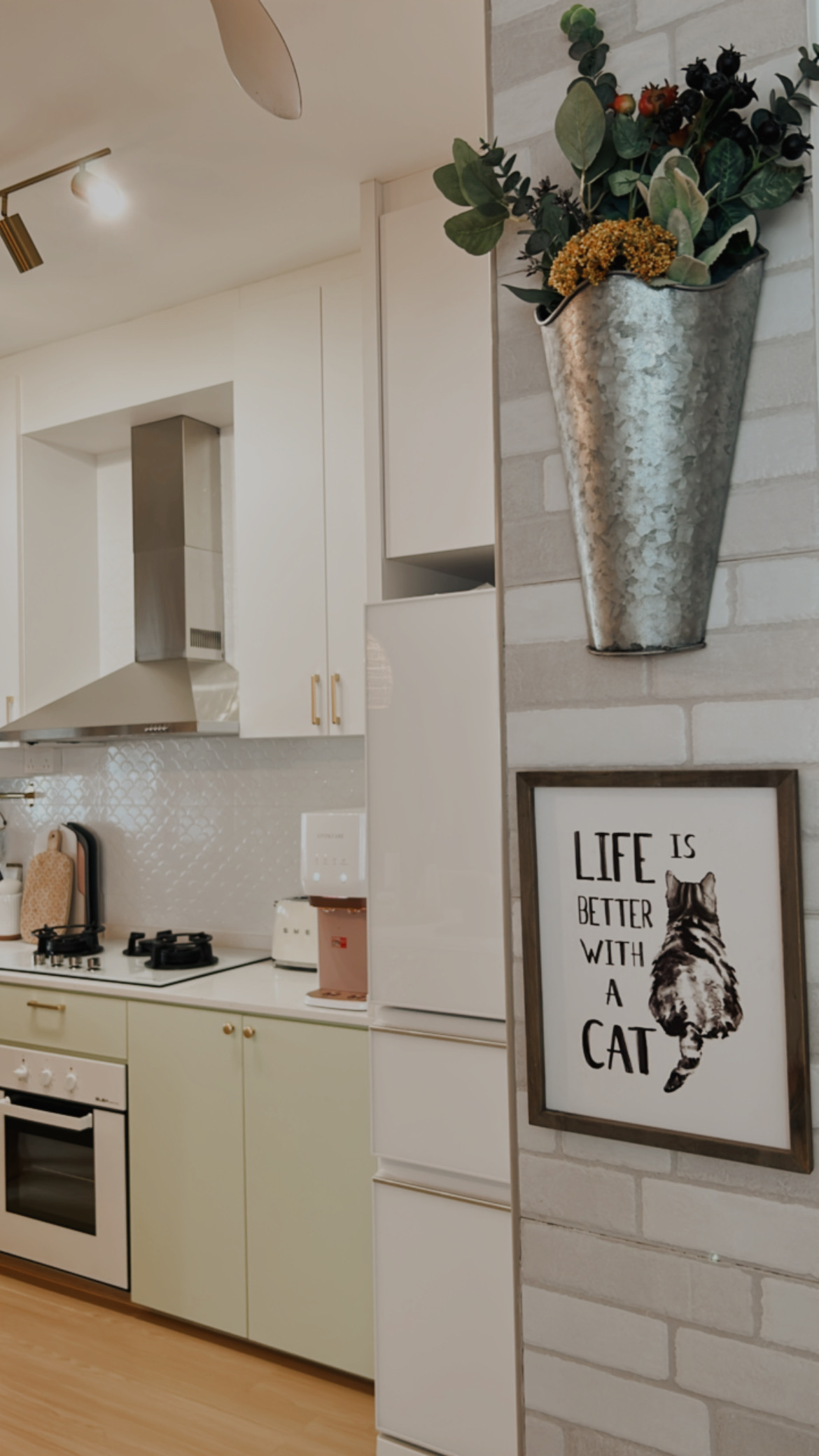 Our bright and airy kitchen ❤️ - Modern kitchen with white cabinets, stainless steel range hood, and light green countertops.