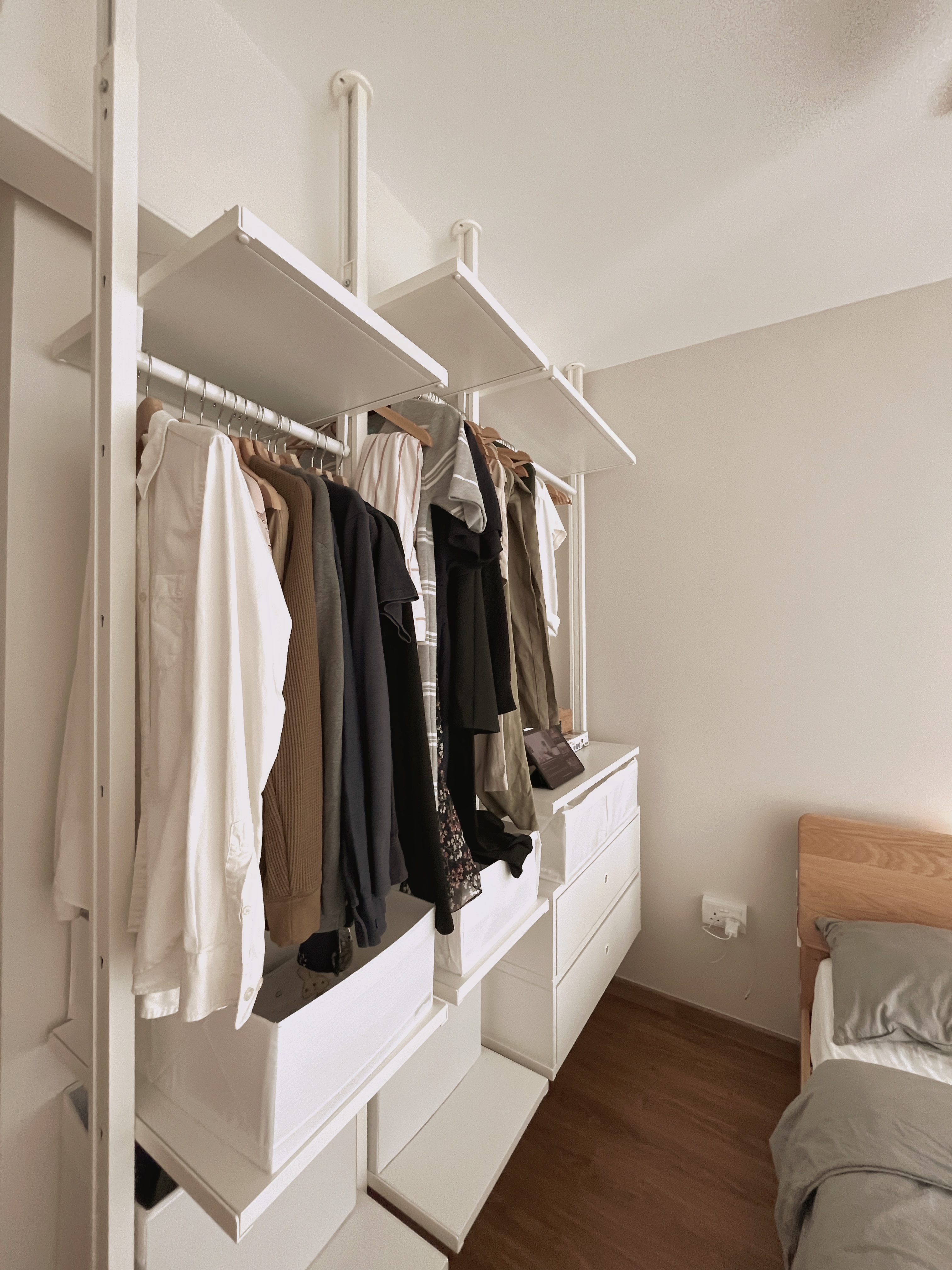 Comfort without clutter - Lagom in the bedroom - White wardrobe with multiple shelves, neatly organized clothes, beige and
